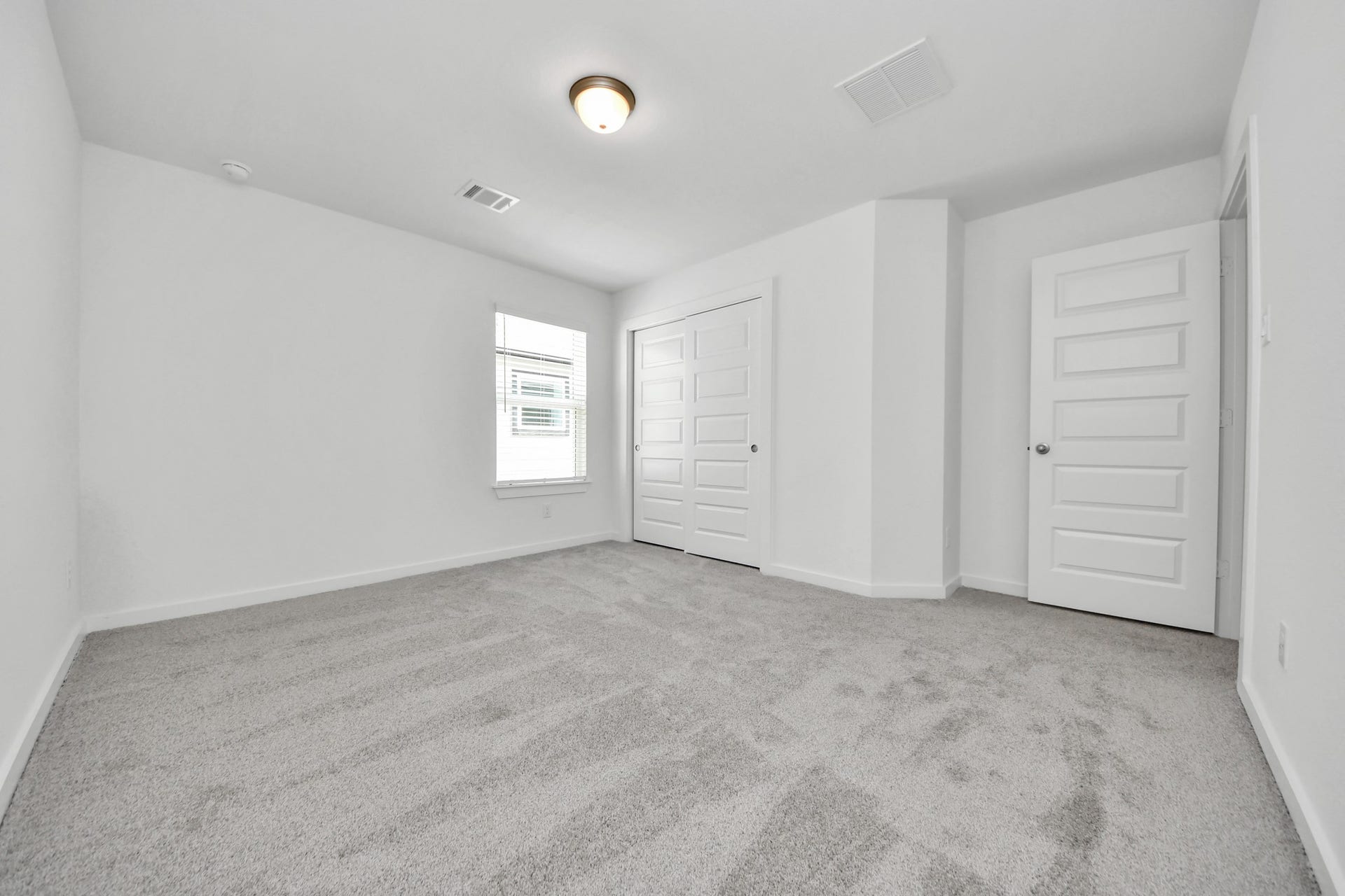 Generously sized secondary bedrooms featuring spacious closets, soft and inviting carpeting underfoot, large windows allowing plenty of natural light, and the added touch of privacy blinds for your personal retreat. Sample photo of completed home with similar floor plan. Actual colors and selections may vary.