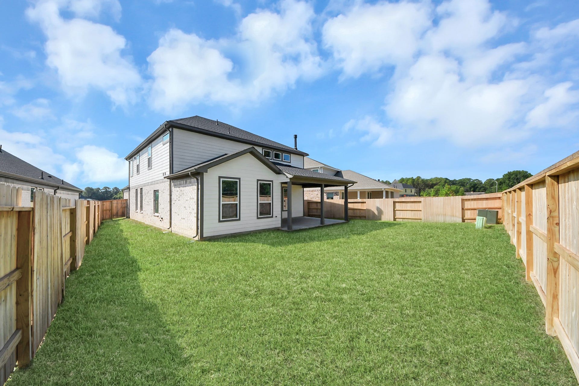 Experience outdoor living at its finest on this expansive covered patio, thoughtfully designed for BBQs and delightful outdoor dining.