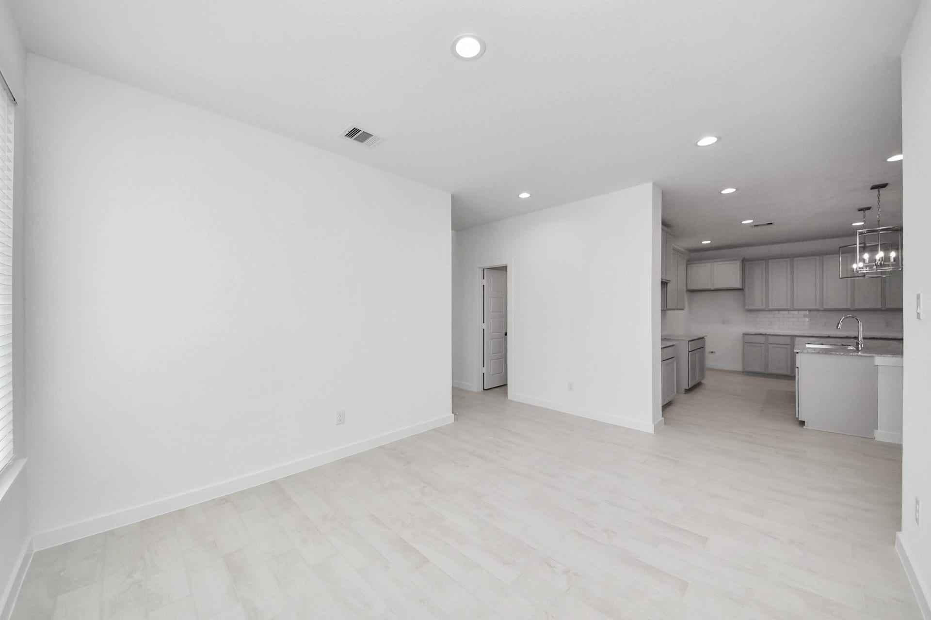 Create lasting memories with your family and friends at the dining table! This expansive dining room showcases sophisticated flooring, custom paint, and seamlessly connects to the family room and kitchen, providing an open and inviting atmosphere