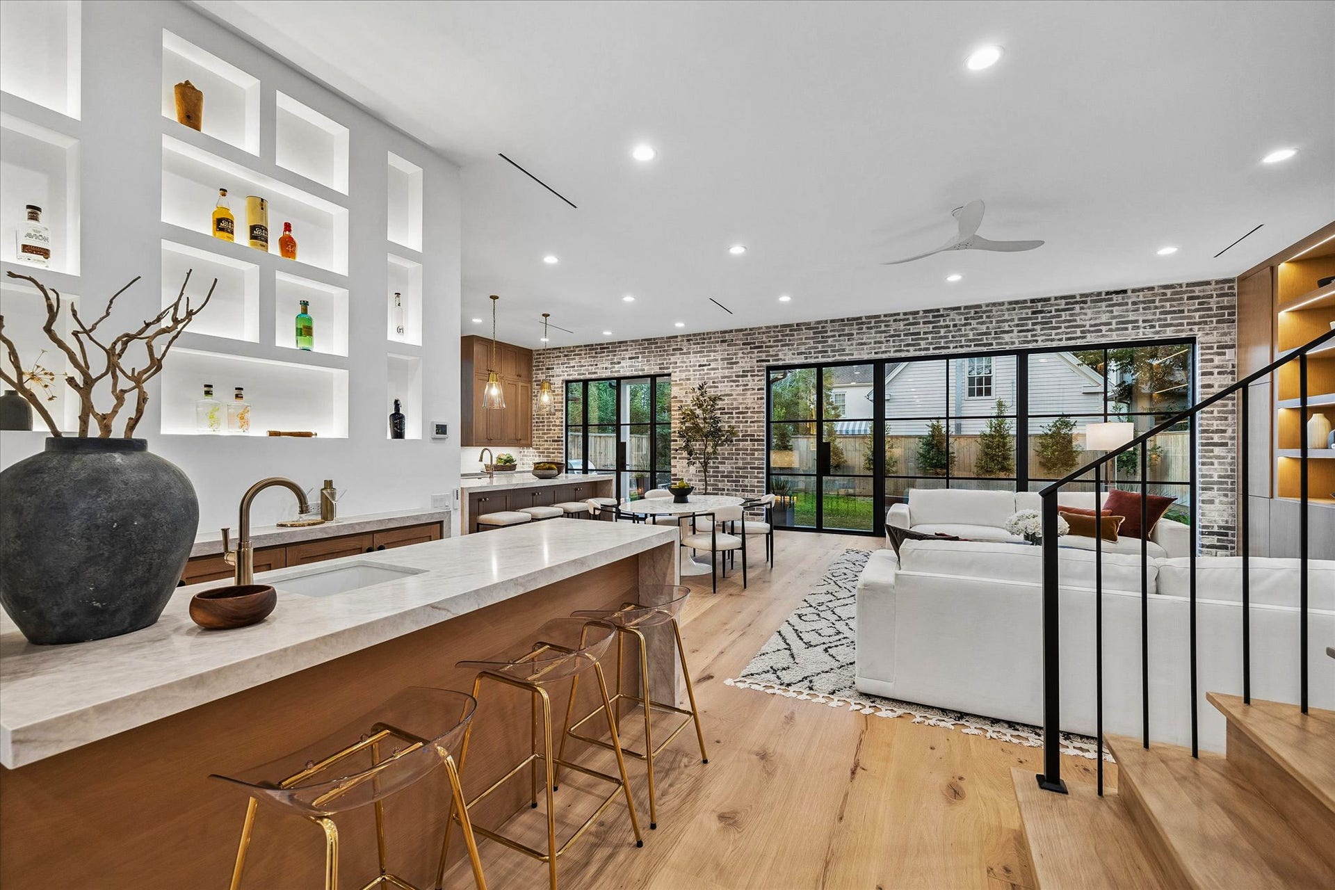 4230 Riley Street, Houston, TX 77005 The open floor plan provides light-filled, expansive, and seamlessly-integrated rooms. This view shows the family room, bar, and kitchen.