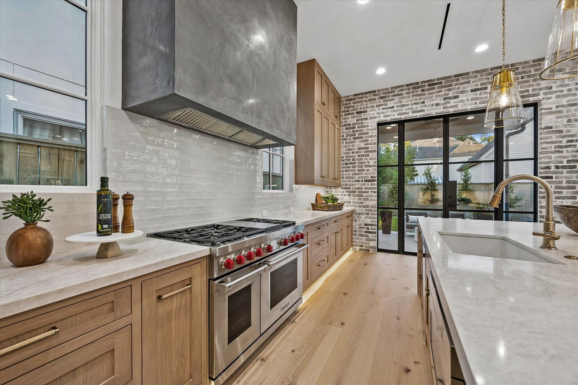 4230 Riley Street, Houston, TX 77005 The spacious kitchen boasts a blend of modern and timeless elements. Quartz countertops and Porcelanosa tile backsplash.