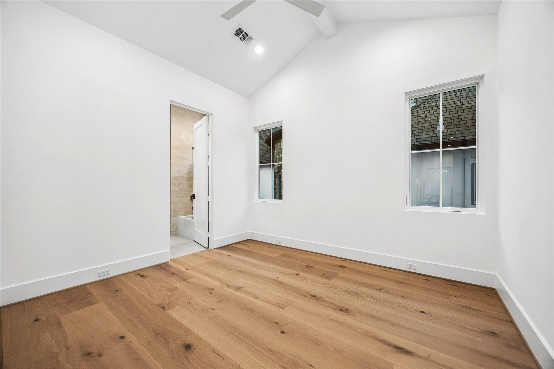 [Secondary Ensuite Bedroom] One of the three ensuite bedrooms - all bedrooms are generous in size with hardwoods and window treatments.