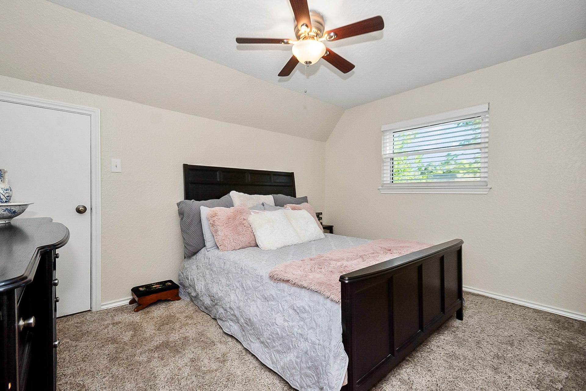 928 Oleander Street, Lake Jackson, TX 77566 Cozy 2nd bedroom with fresh paint in neutral tones, plush carpeting, and a ceiling fan for added comfort.