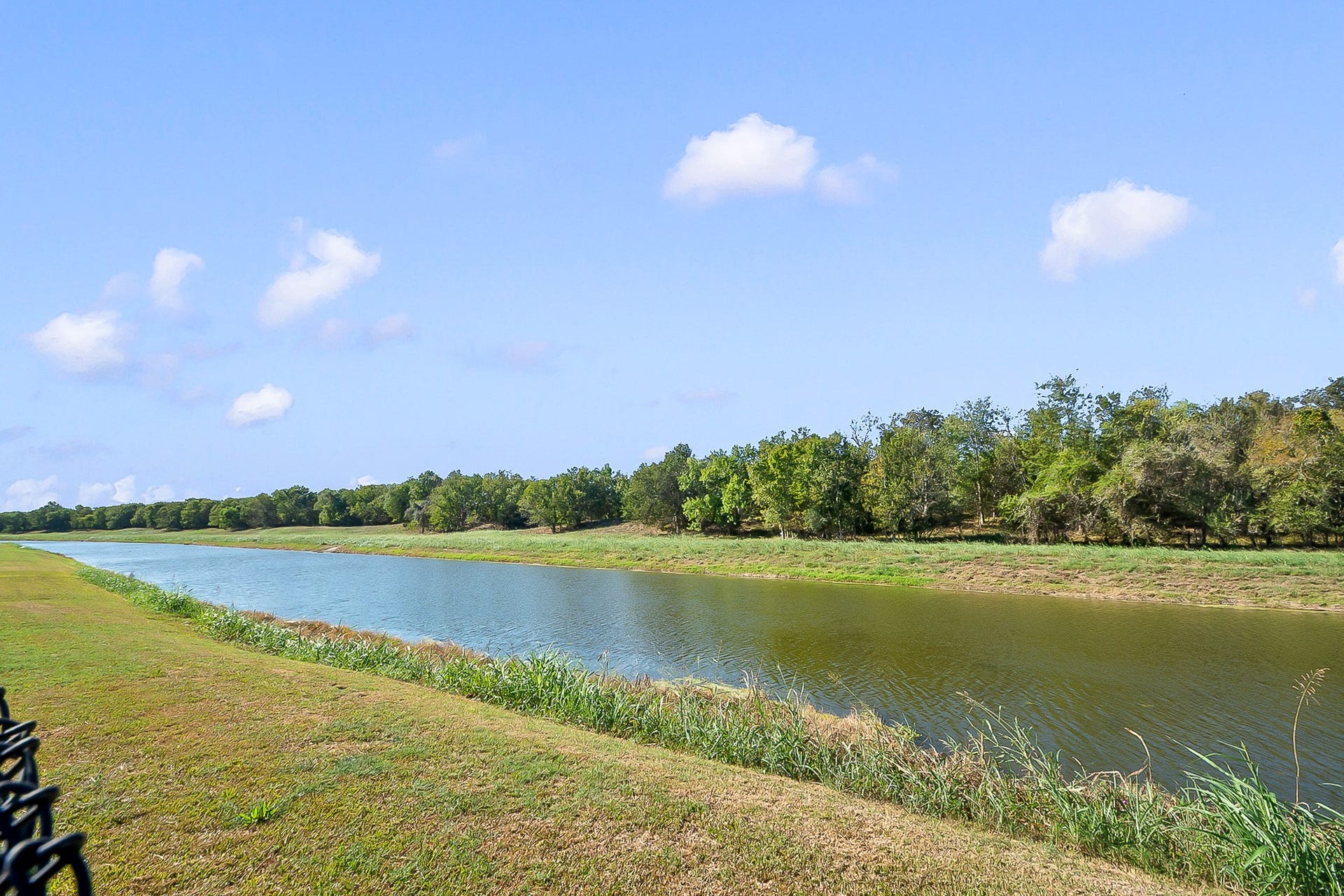 928 Oleander Street, Lake Jackson, TX 77566 Tranquil waterfront views with lush greenery and a serene, expansive sky create a perfect backdrop for relaxation and outdoor enjoyment.