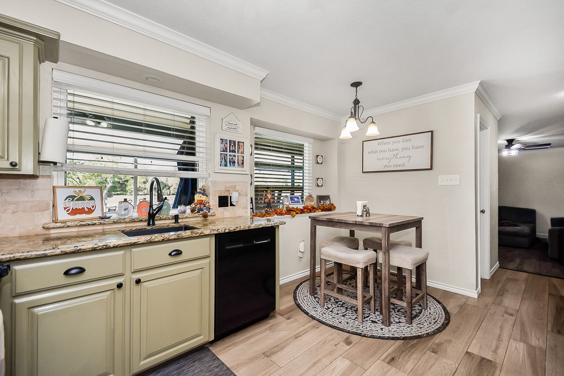 928 Oleander Street, Lake Jackson, TX 77566 Charming kitchen with granite countertops, stylish cabinetry, and a cozy breakfast nook. The open layout and large windows fill the space with natural light.