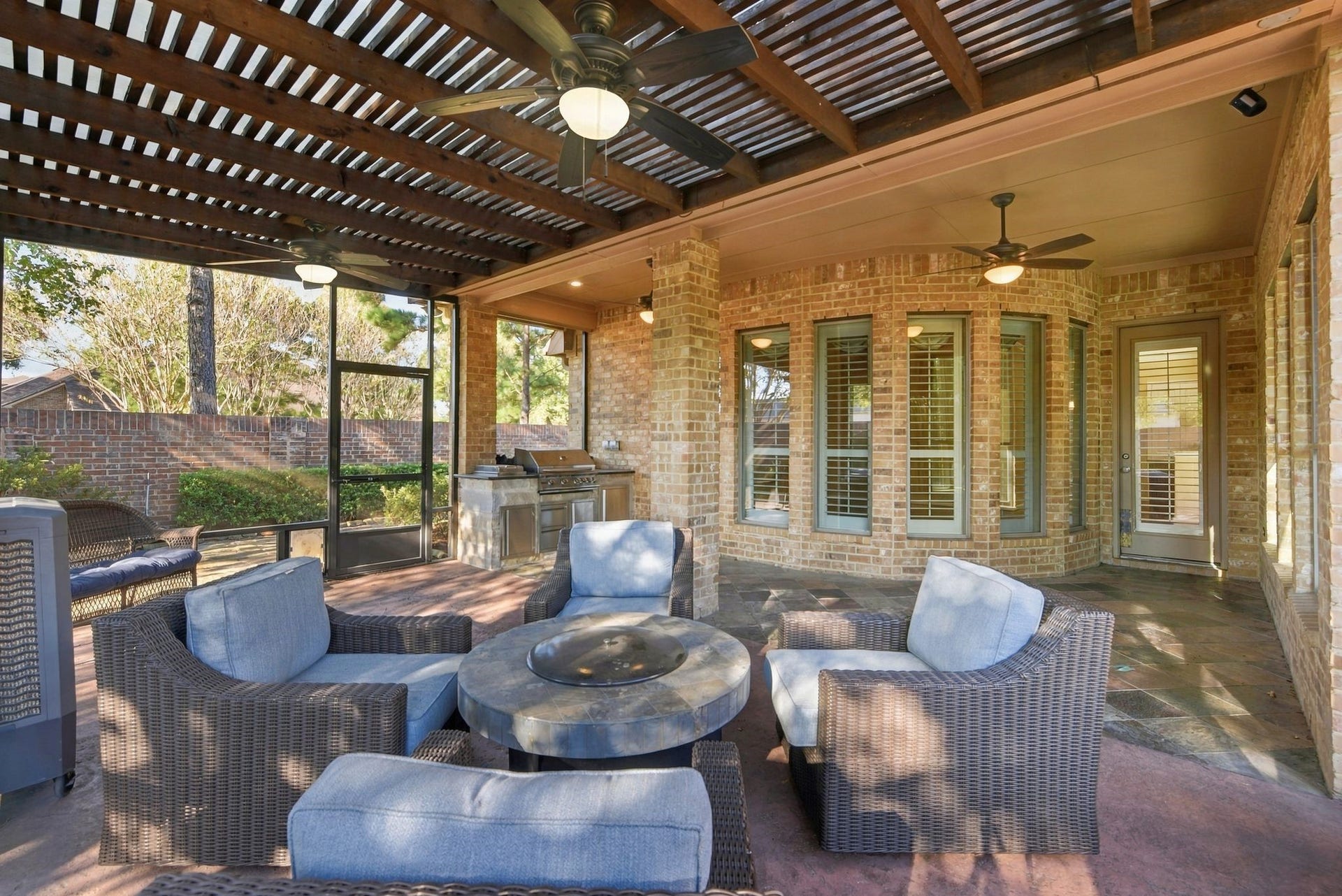 Experience outdoor luxury with this covered patio that is completely screened in.