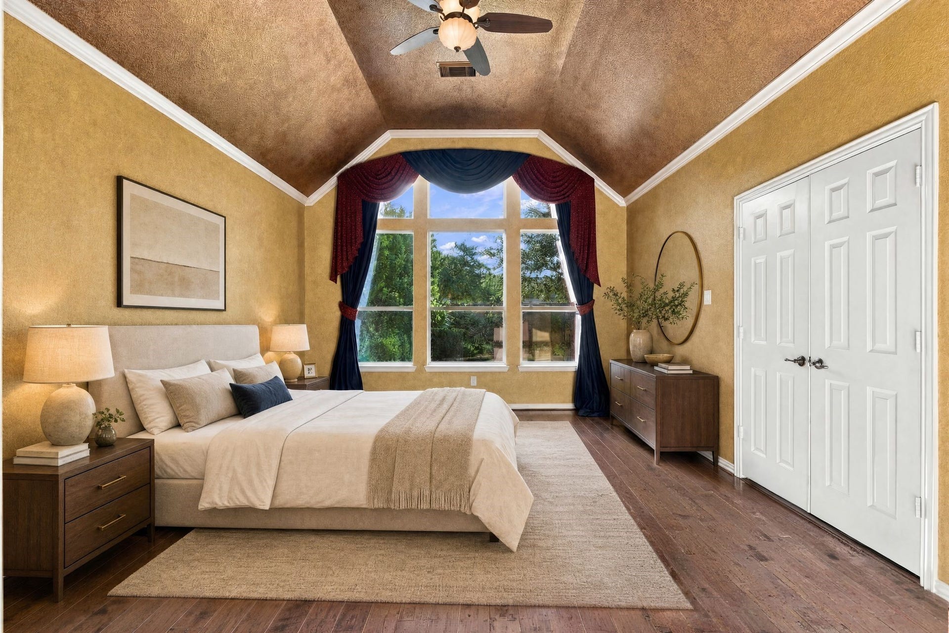 Elegant primary bedroom with vaulted ceiling, large windows, and rich hardwood floors, offering a serene and spacious atmosphere. Space is virtually staged.