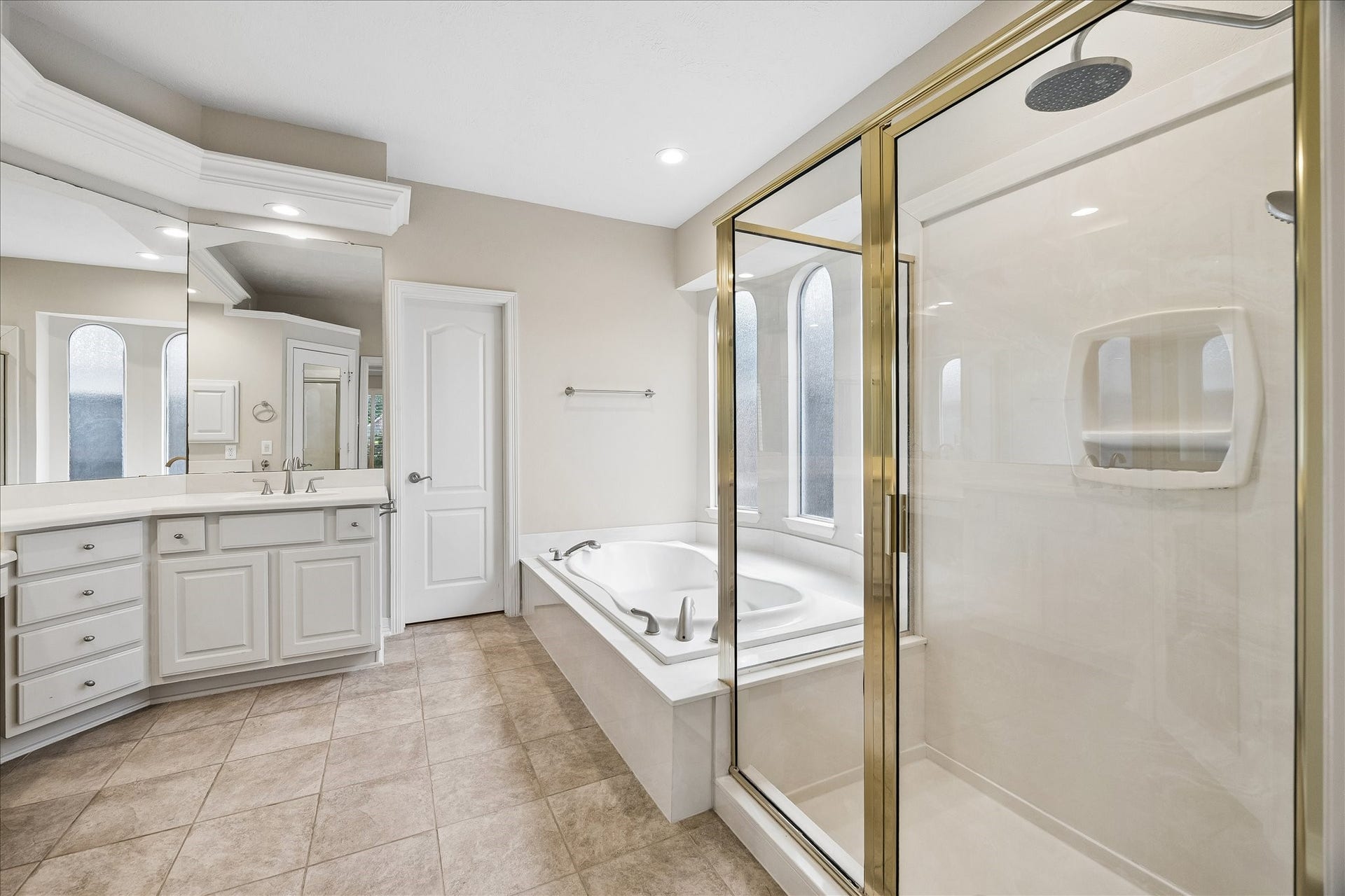 The primary ensuite boasts dual vanities, jetted tub and separate shower, plus walk in closet.