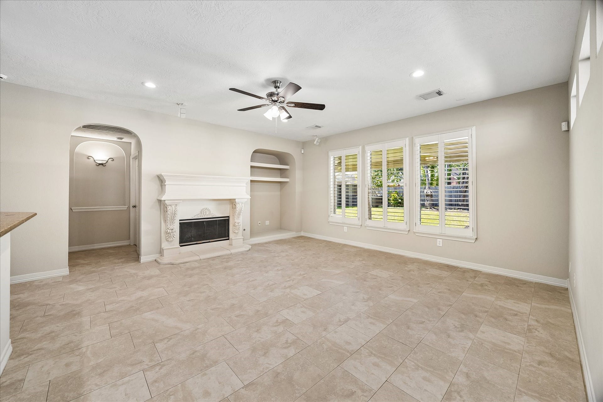 An open concept plan perfect for entertaining. The family room flows effortlessly into the kitchen & breakfast areas, and offers backyard access & endless views. The archway to the left leads to the powder room and primary suite.