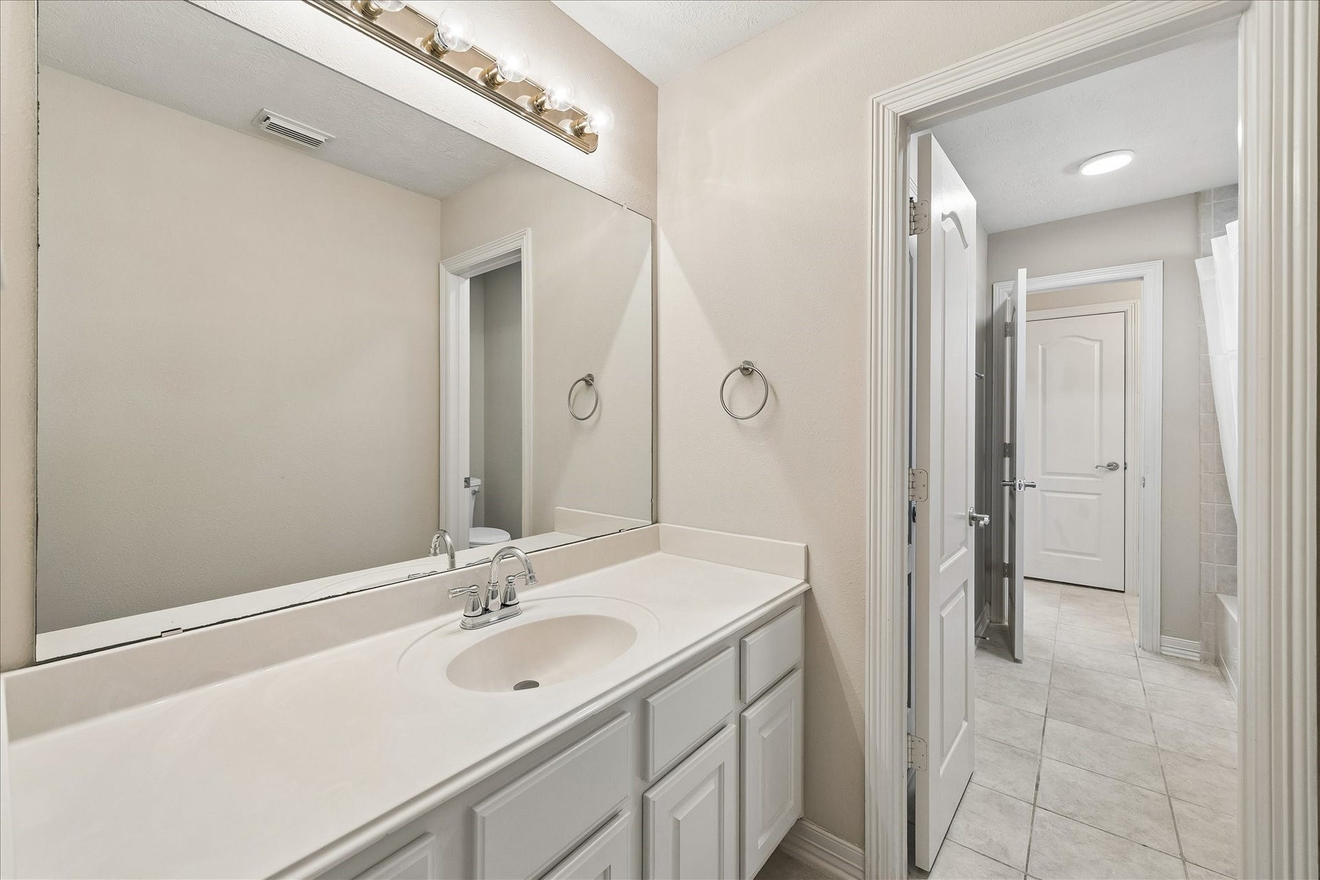 The Hollywood bath offers a private vanity for each bedroom.