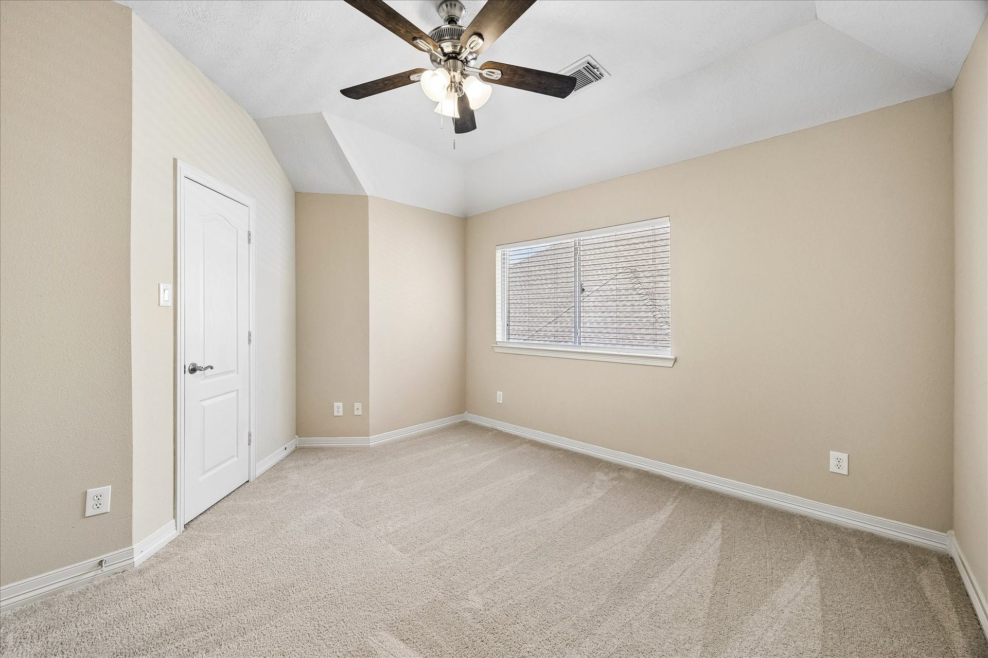 This 3rd bedroom with vaulted ceiling and walk-in closet connects with a Hollywood bath to bedroom 4.