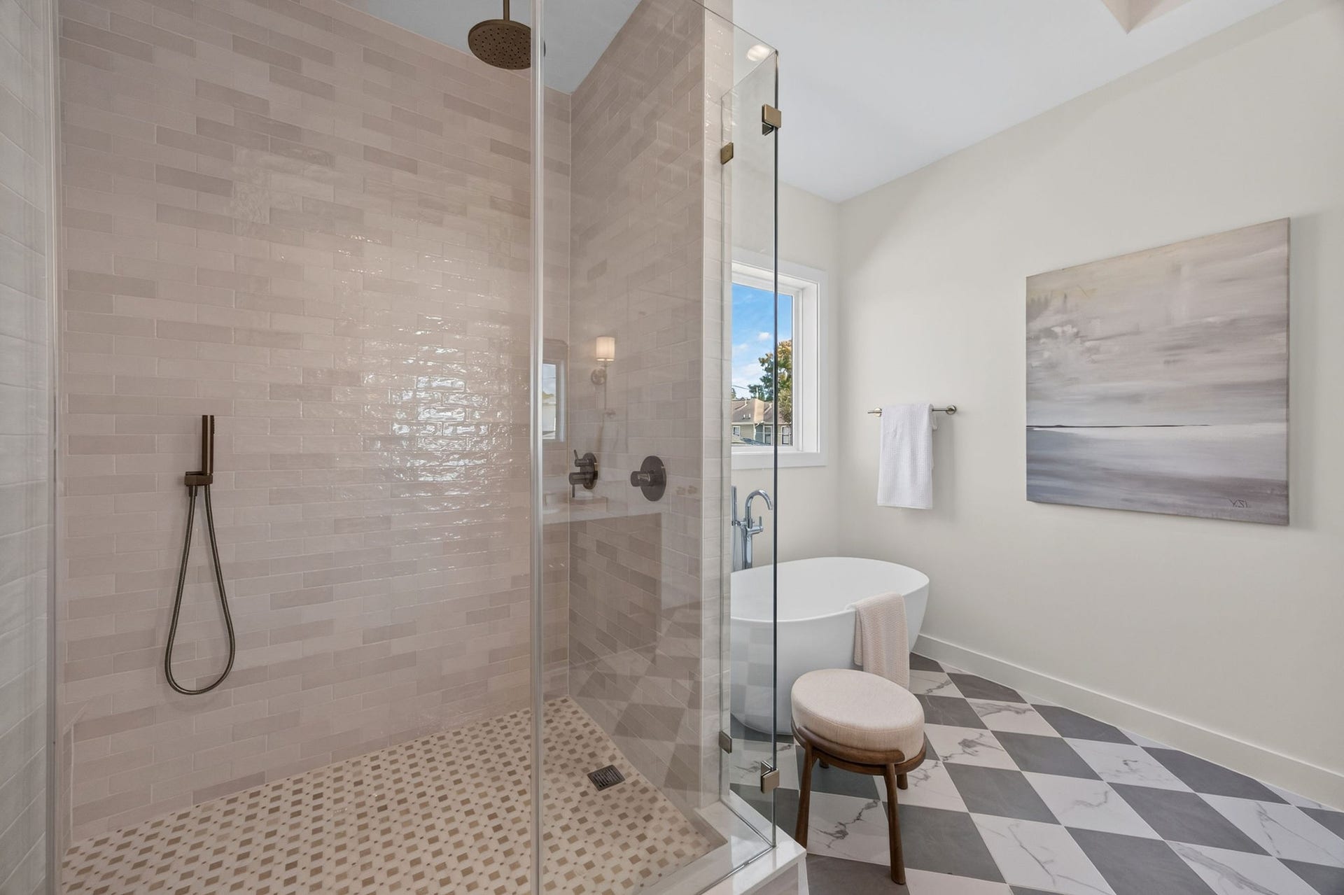 1726 Saxon Drive, Houston, TX 77018 A closer look at the primary bathroom's spacious walk-in shower, featuring textured tile, frameless glass, and beautiful natural finishes.