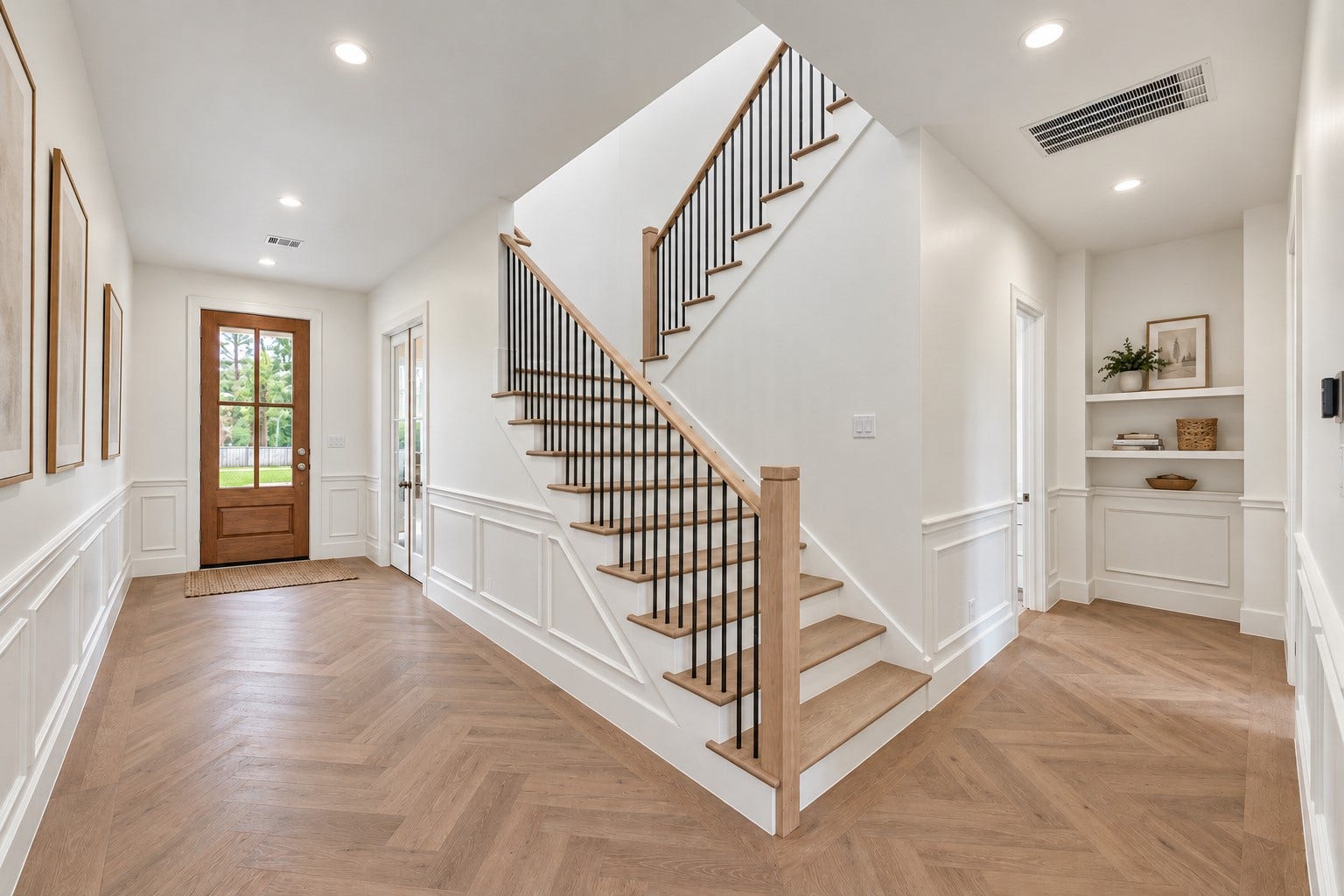 1726 Saxon Drive, Houston, TX 77018 The grand entryway showcases herringbone wood floors and custom millwork, with a formal study by the main entrance.