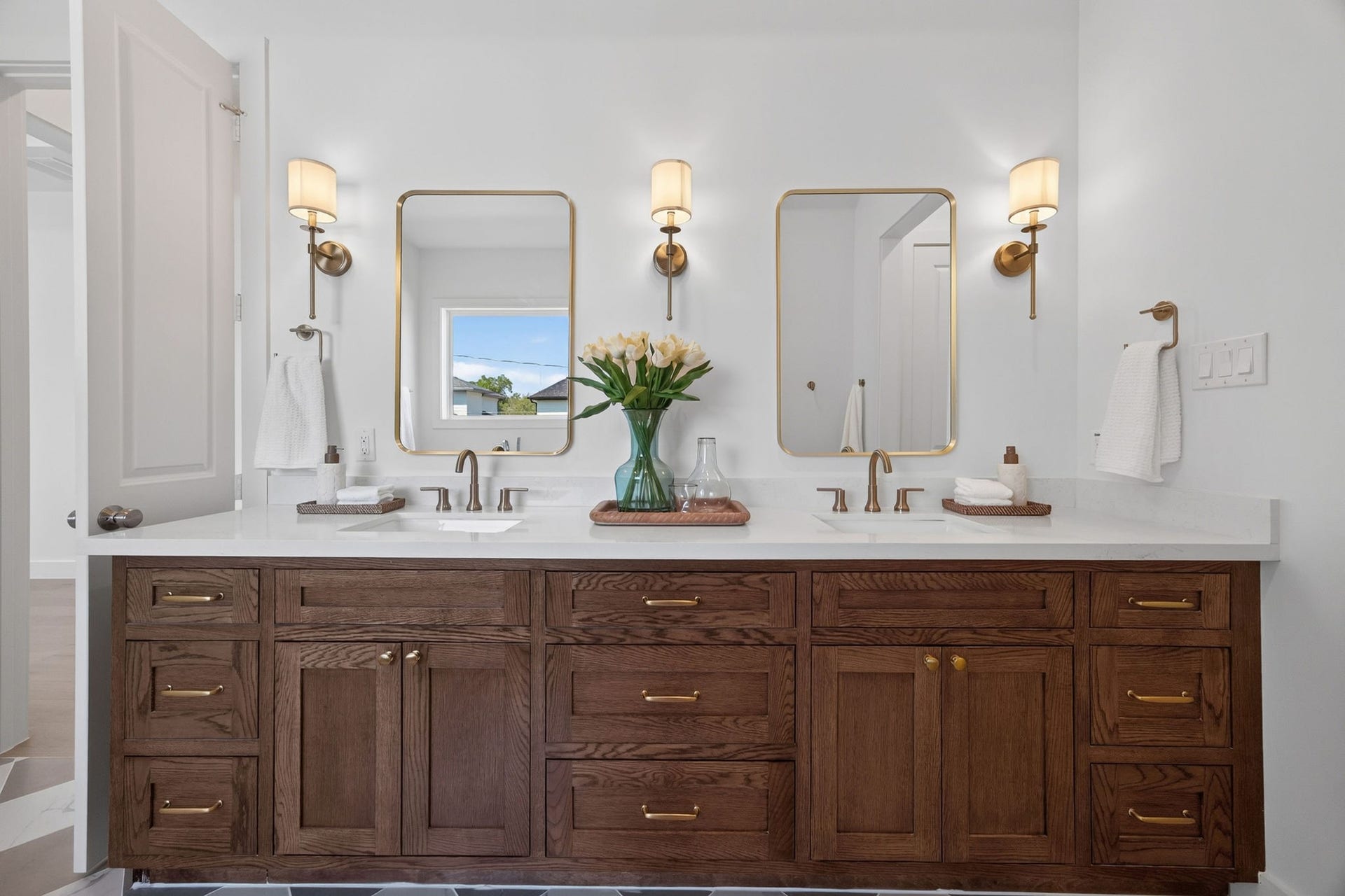 1726 Saxon Drive, Houston, TX 77018 Timeless elegance with custom wood cabinetry, warm brass accents, and a beautifully appointed double vanity.