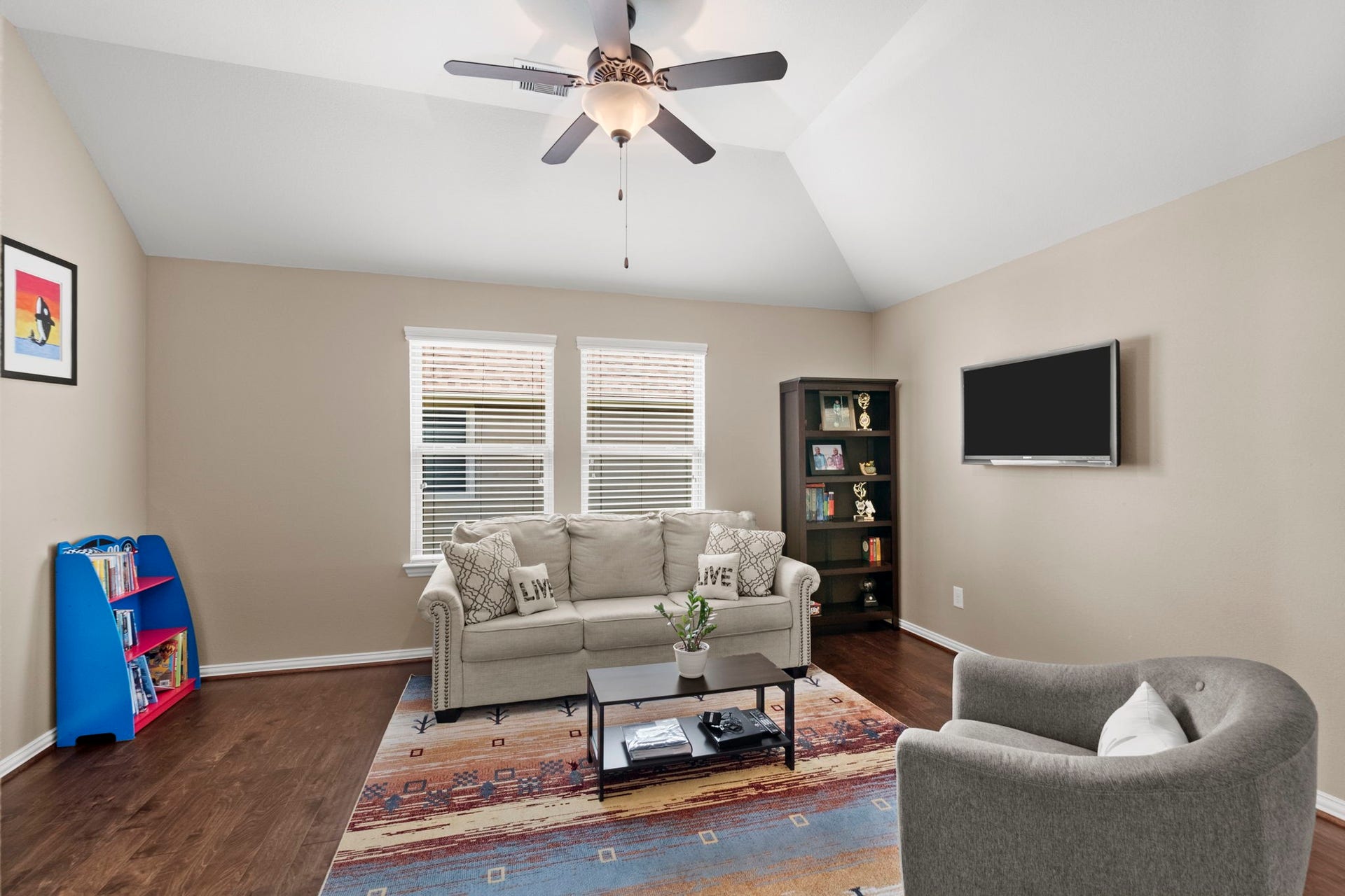 19519 Arbor Lodge Drive, Cypress, TX 77433 The upstairs game room with wood floors & vaulted ceilings provides a comfortable space for relaxation & entertainment.