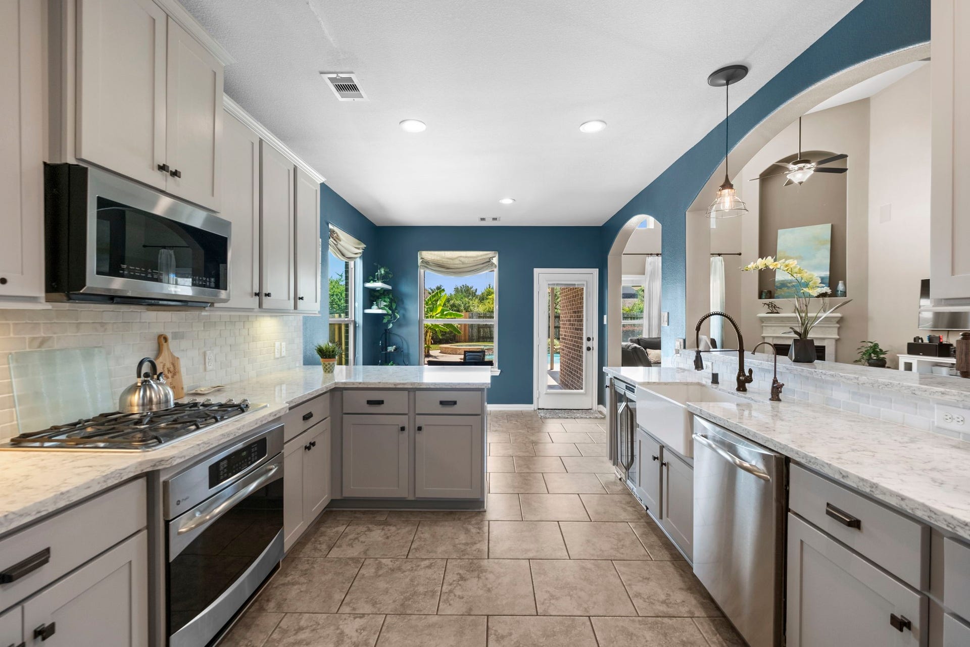 19519 Arbor Lodge Drive, Cypress, TX 77433 This kitchen features modern appliances, spacious countertops, and sleek cabinetry. The room flows seamlessly into adjacent living areas, creating a perfect space for entertaining.