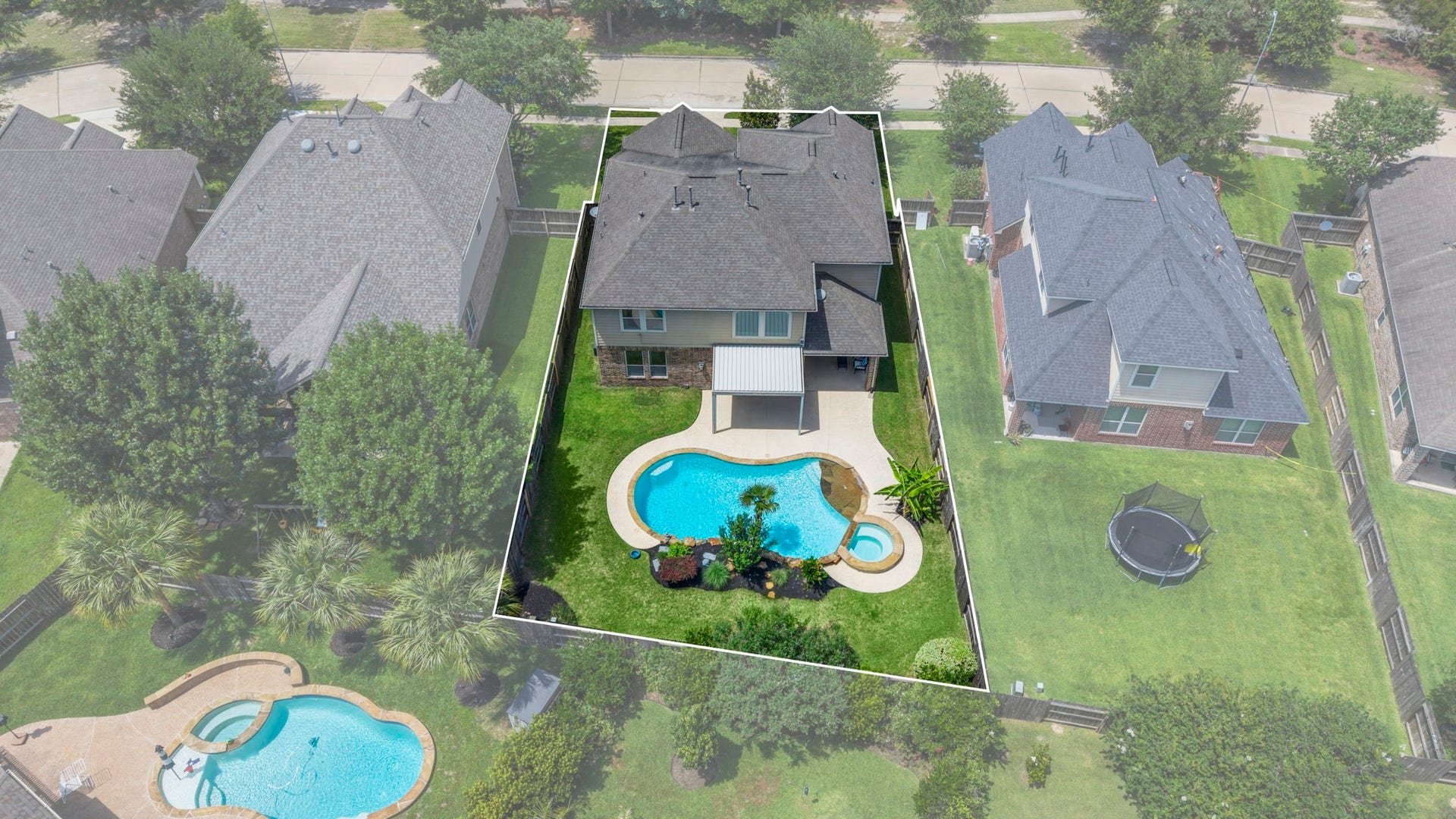 19519 Arbor Lodge Drive, Cypress, TX 77433 This aerial photo showcases a spacious two-story home with a fenced backyard featuring a pool and spa.