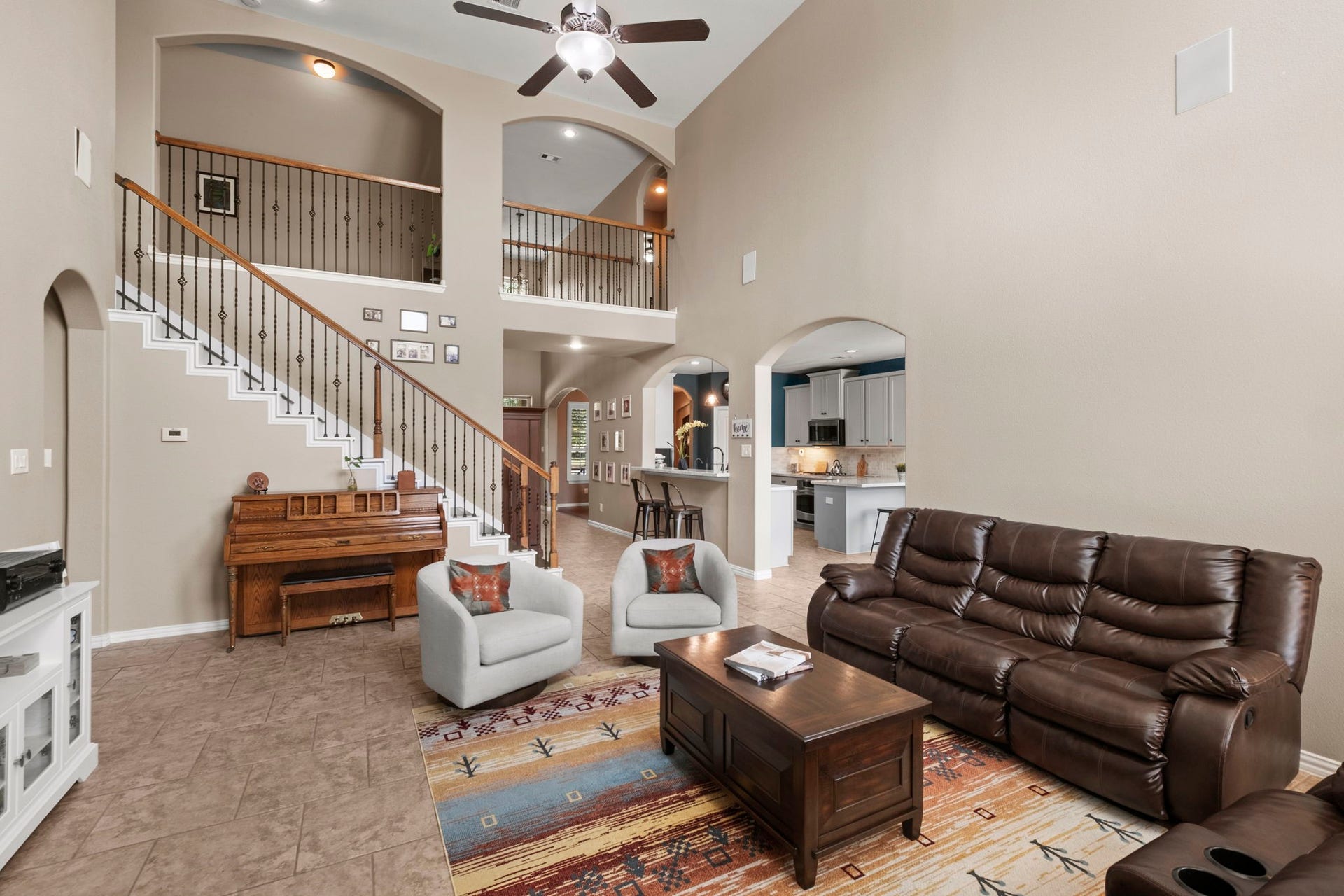 19519 Arbor Lodge Drive, Cypress, TX 77433 The open layout includes a view of the kitchen and dining area, with the staircase leading to an upper level.