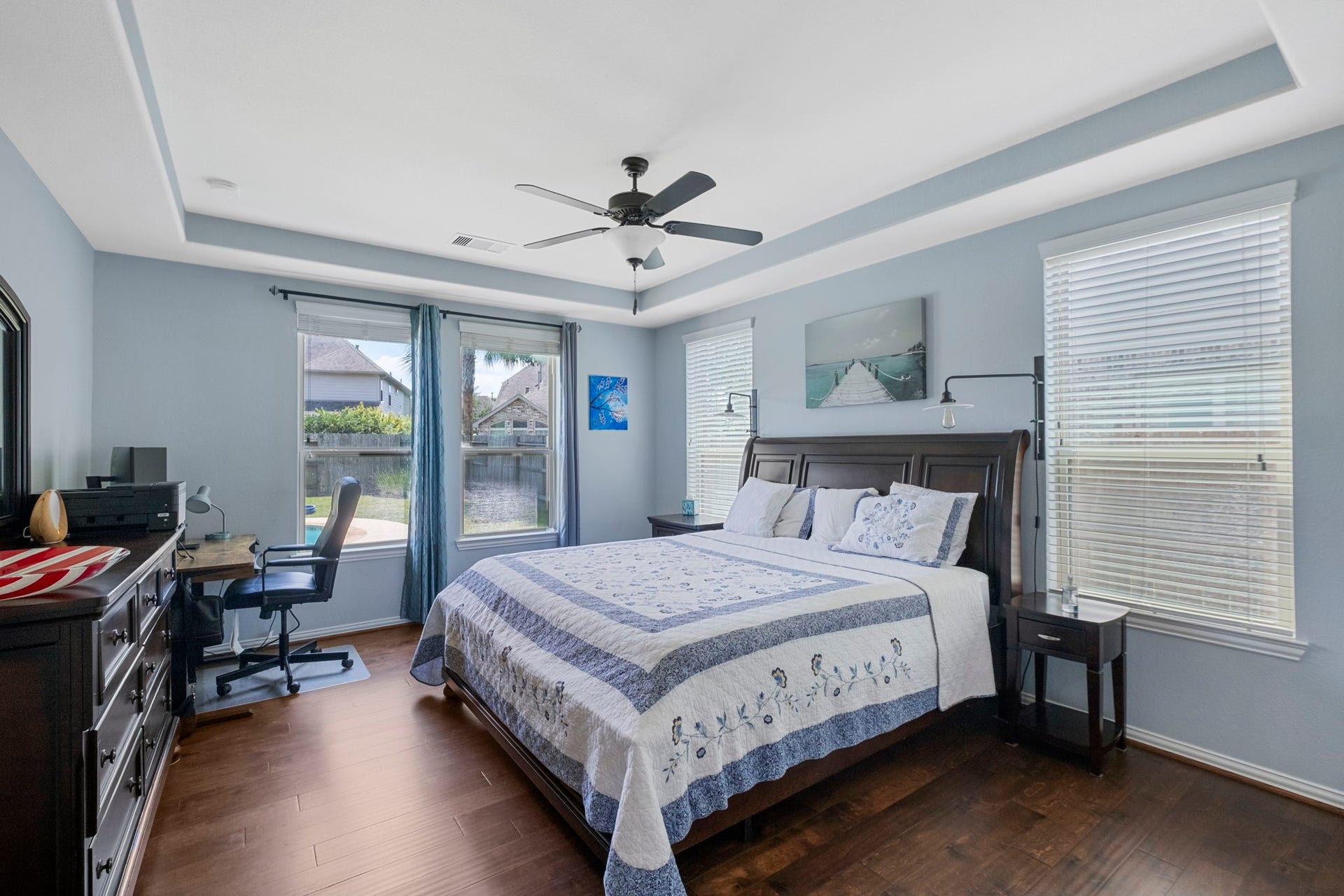 19519 Arbor Lodge Drive, Cypress, TX 77433 Primary bedroom with wood flooring & tray ceilings offers wonderful backyard views.