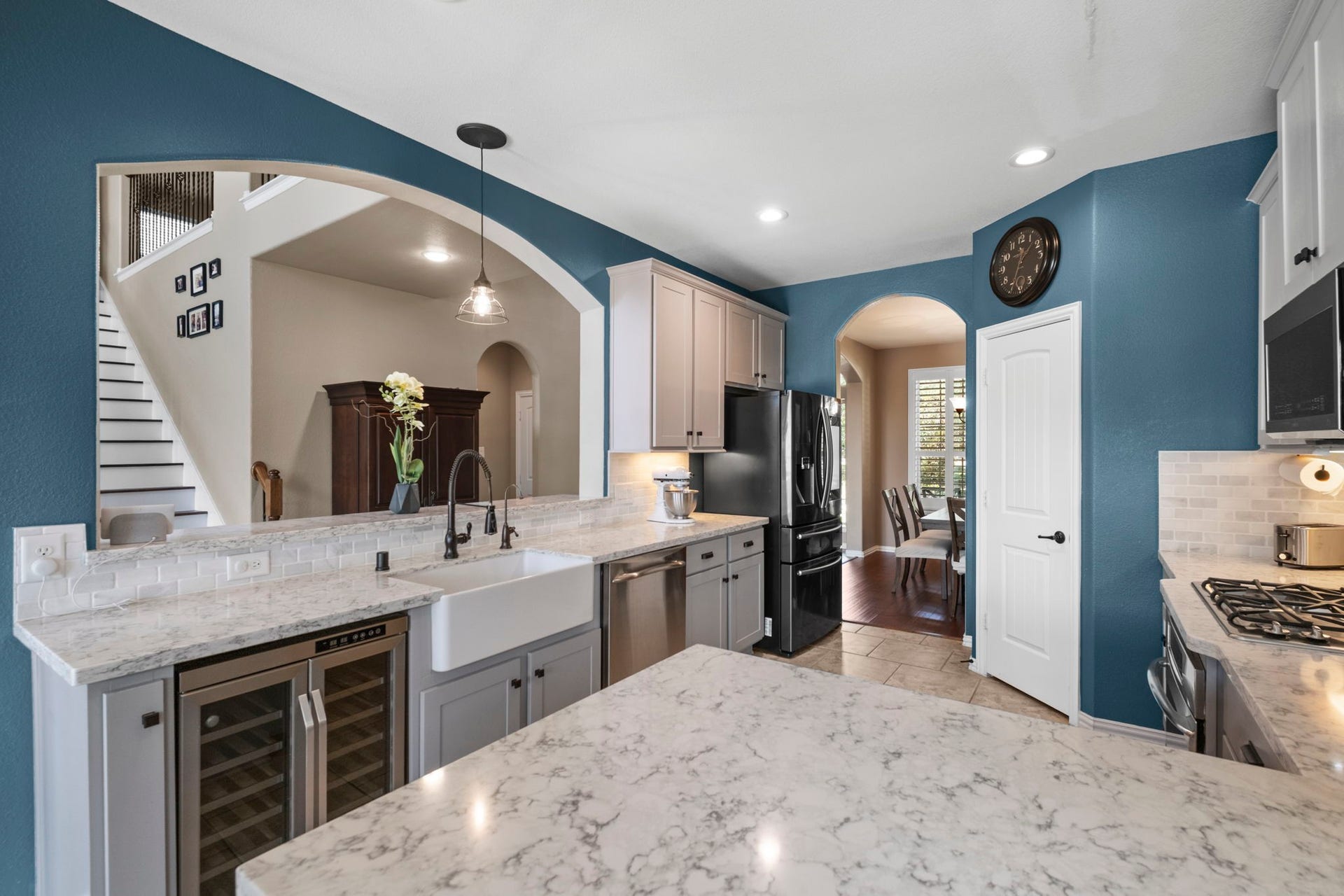 19519 Arbor Lodge Drive, Cypress, TX 77433 This kitchen features modern amenities with quartz countertops, a farmhouse sink, and stainless steel appliances.