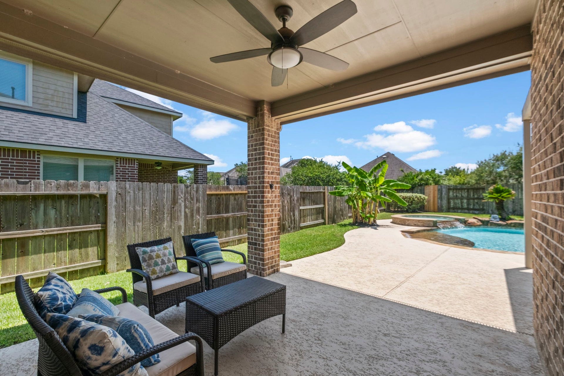 19519 Arbor Lodge Drive, Cypress, TX 77433 A covered patio provides a comfortable seating area & overlooks a well-maintained backyard.