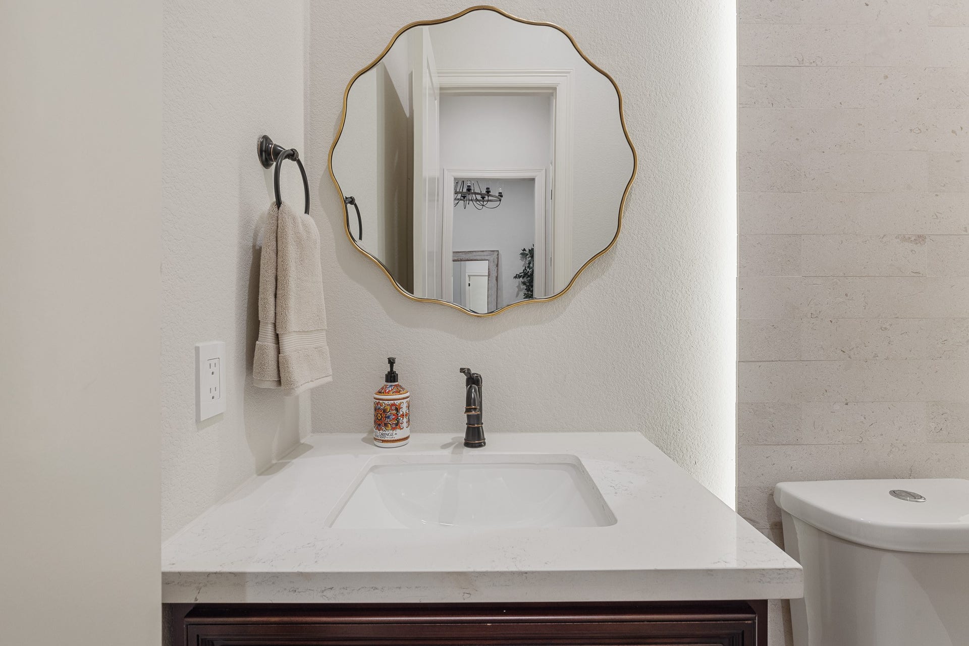 12134 S Tara Plantation Drive, Tomball, TX 77375 Half bath with brush nickel finishes. Back lit limestone wall.