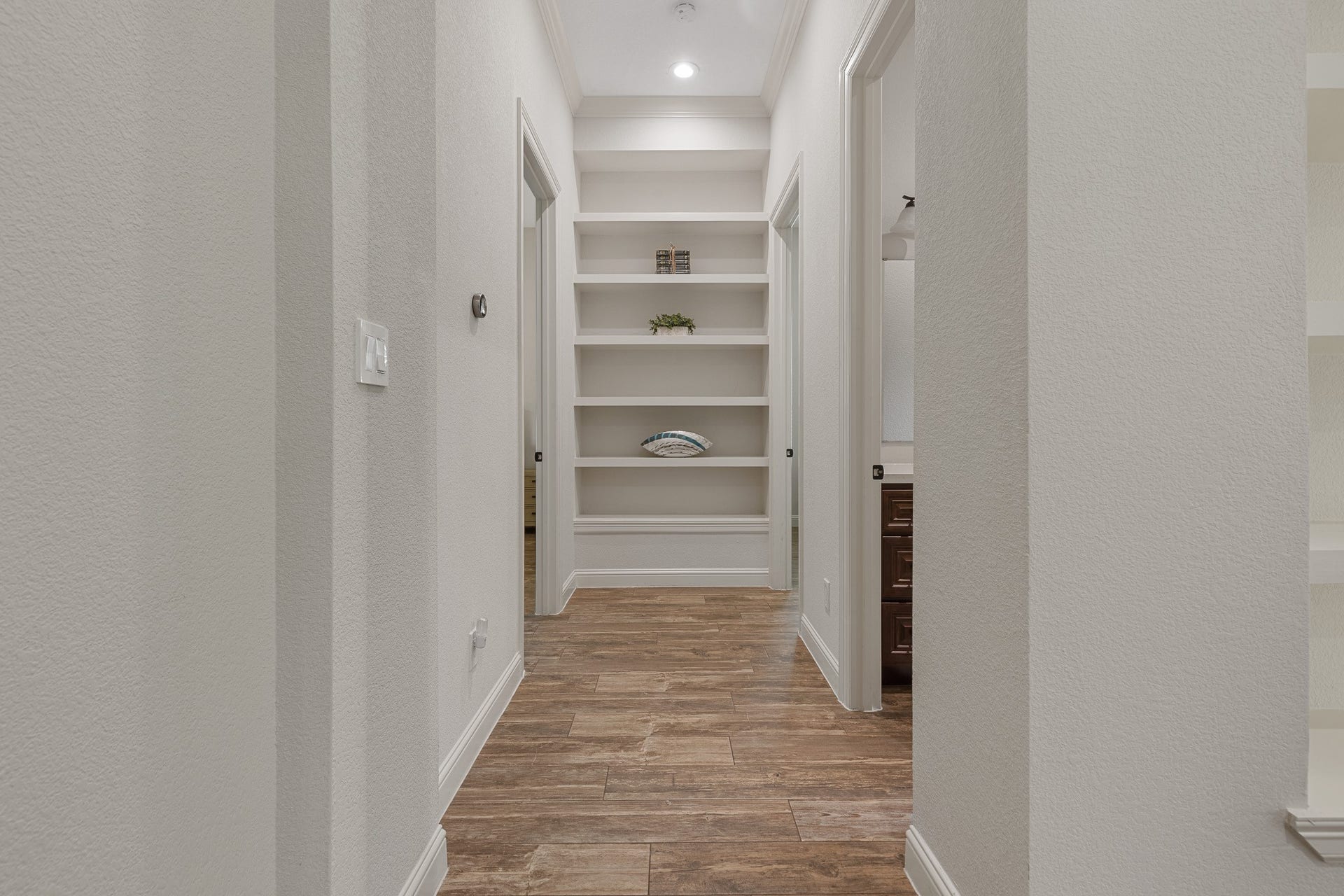 12134 S Tara Plantation Drive, Tomball, TX 77375 Hall with built-in shelving and recessed lighting.