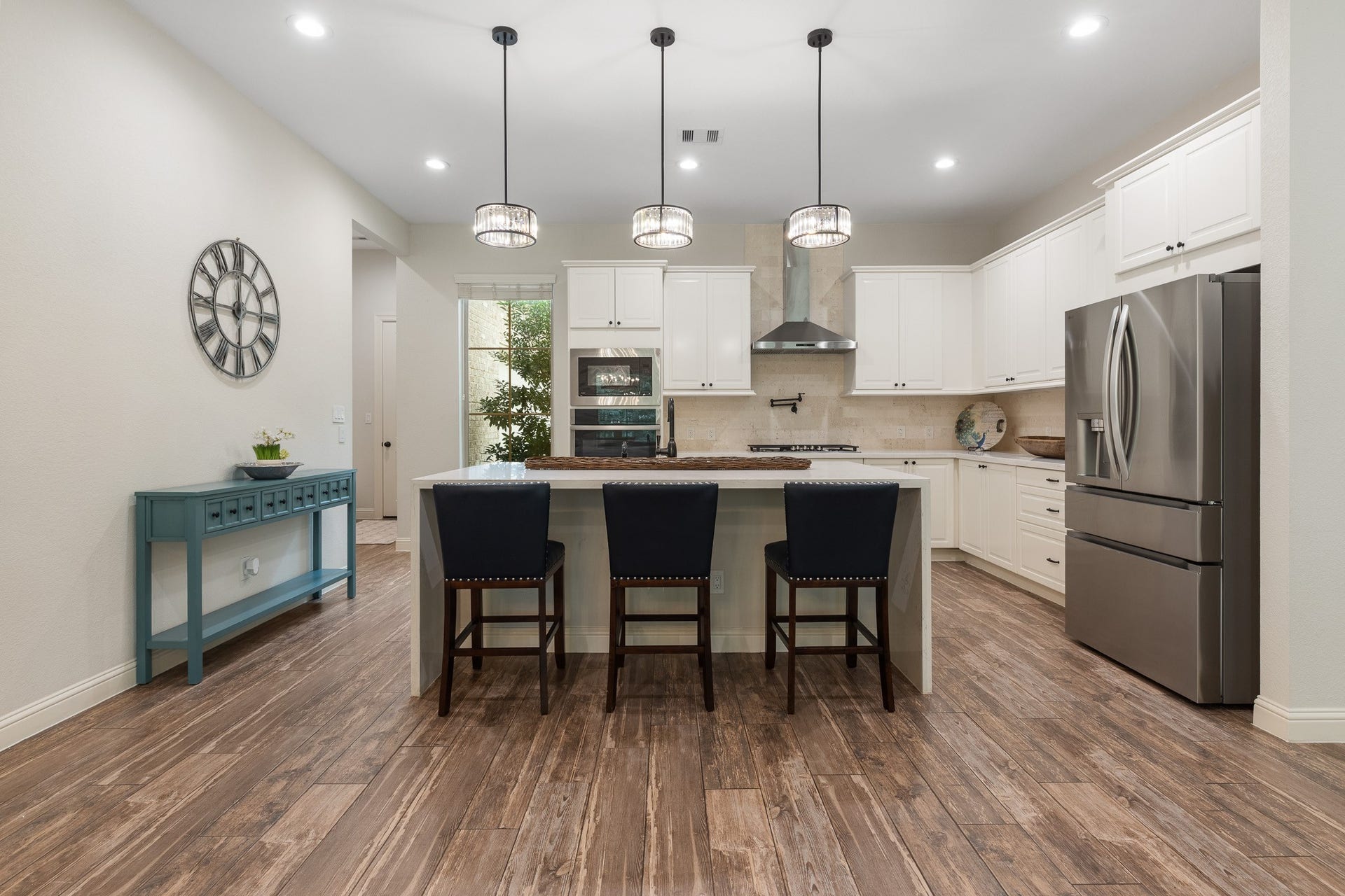 12134 S Tara Plantation Drive, Tomball, TX 77375 Kitchen with pendant lighting on a dimmer switch over waterfall island.
