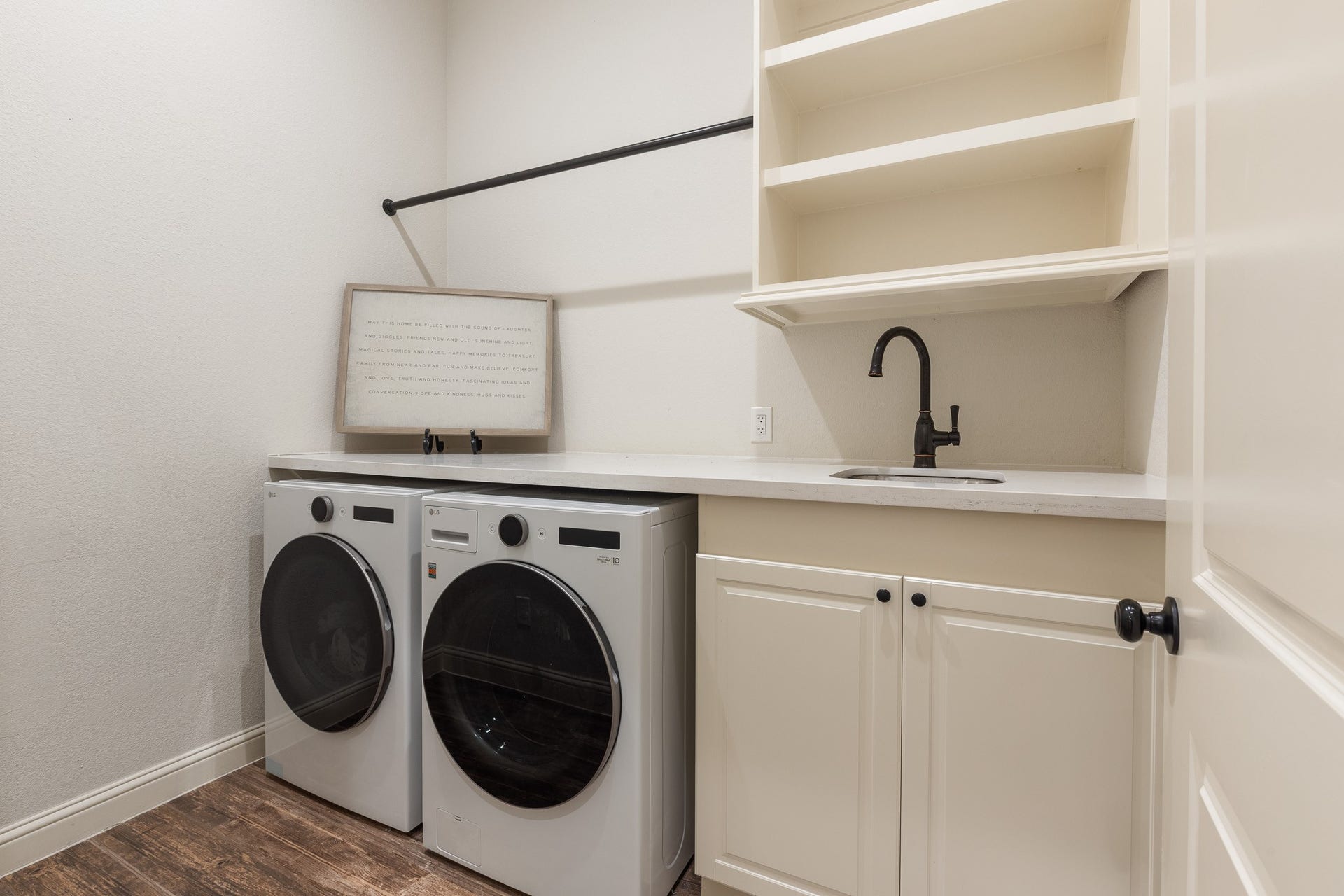 12134 S Tara Plantation Drive, Tomball, TX 77375 Laundry room with built-in shelving, utility sink.