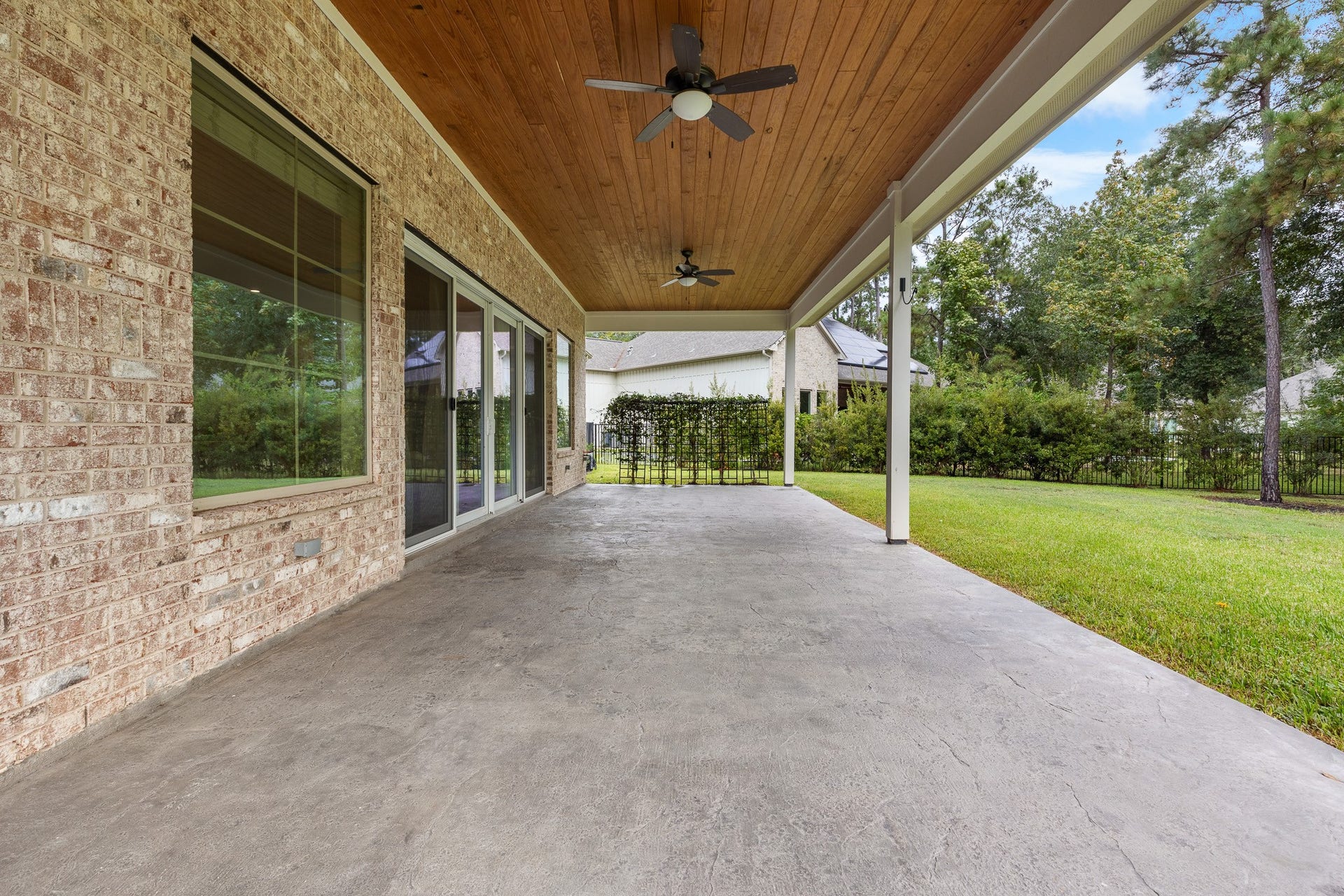 12134 S Tara Plantation Drive, Tomball, TX 77375 Patio with cedar ceiling and 2 ceiling fan.