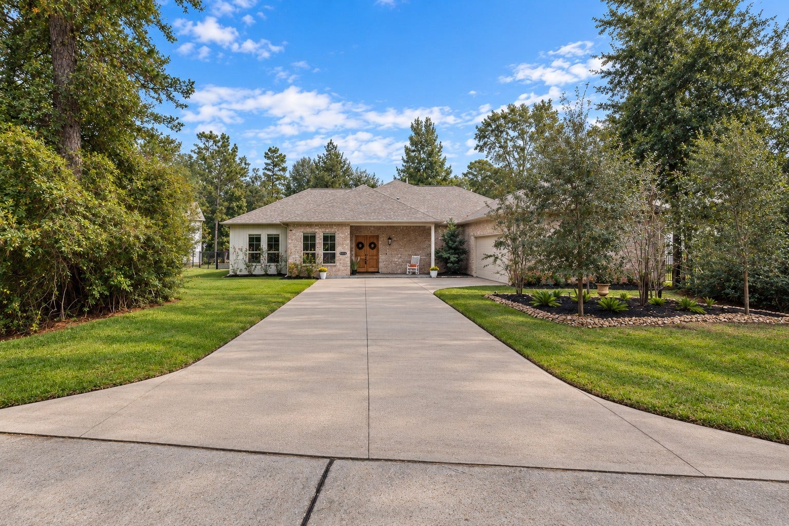 12134 S Tara Plantation Drive, Tomball, TX 77375 Decorative stone added around front-yard trees, enhancing curb appeal while reducing maintenance and erosion. Boxwood bushes installed next to the garage, designed to mature into a cohesive, elegant hedge that adds structure and visual balance to the landscape.