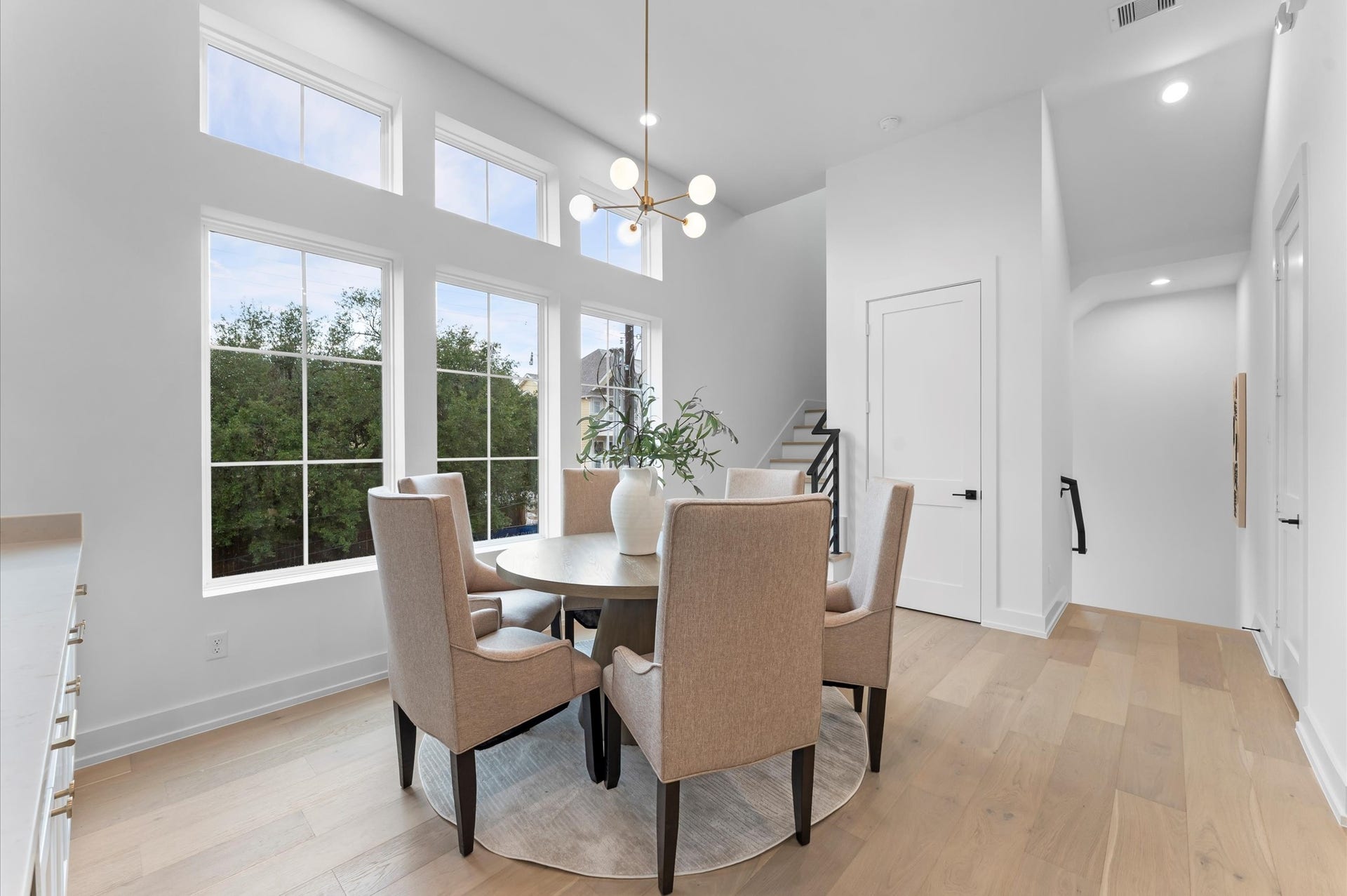 Second floor dining with elevator shaft between stairs.