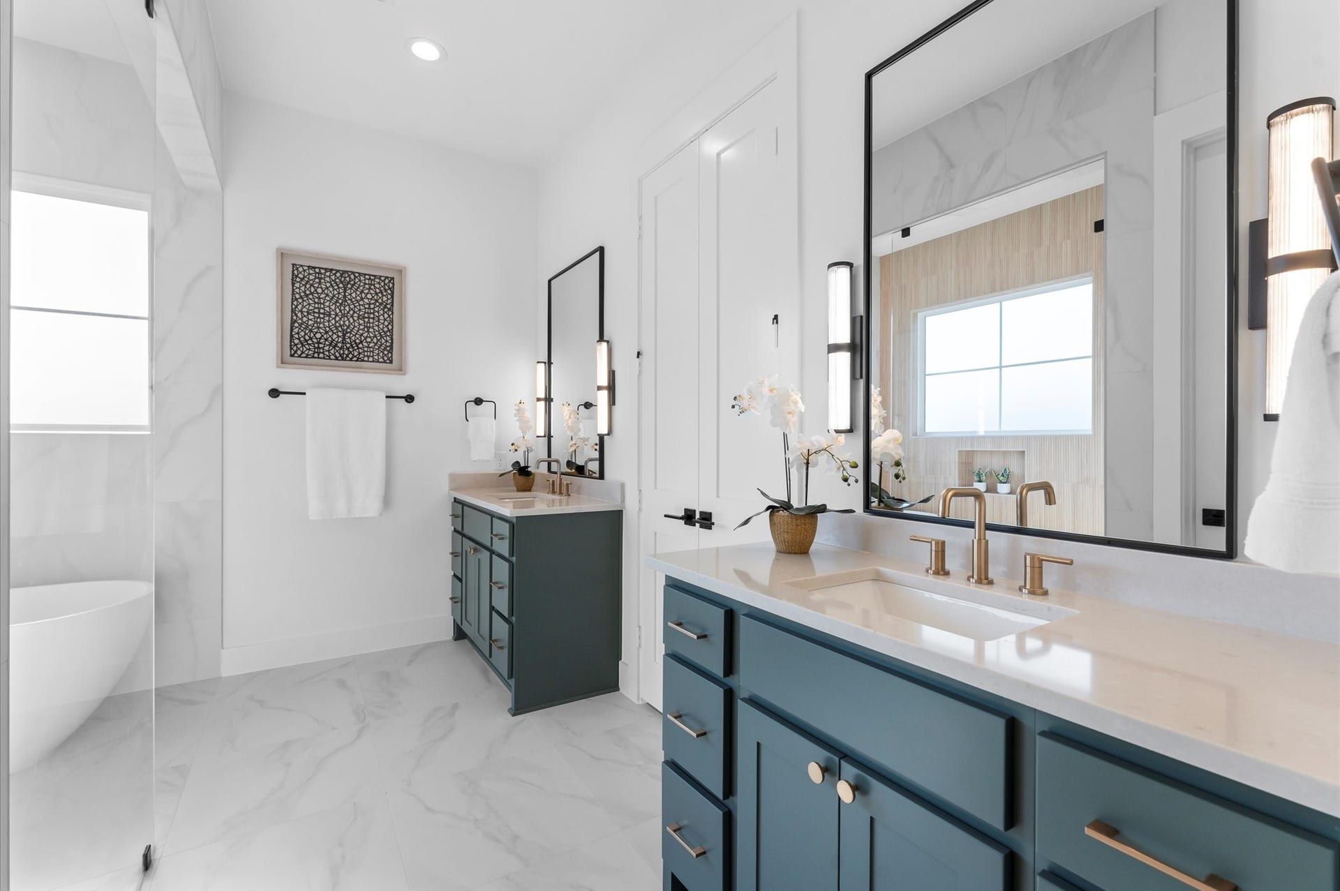 Primary bath features double sinks, curbless shower and separate soaking tub.