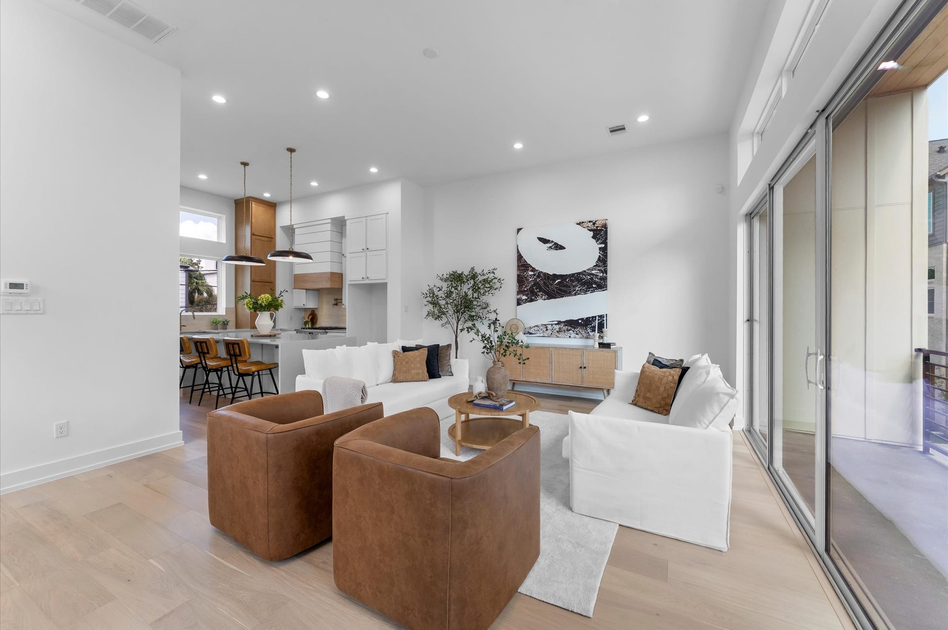 Bright, open living area with soaring ceilings, expansive sliding glass doors and seamless flow to the covered outdoor living space.