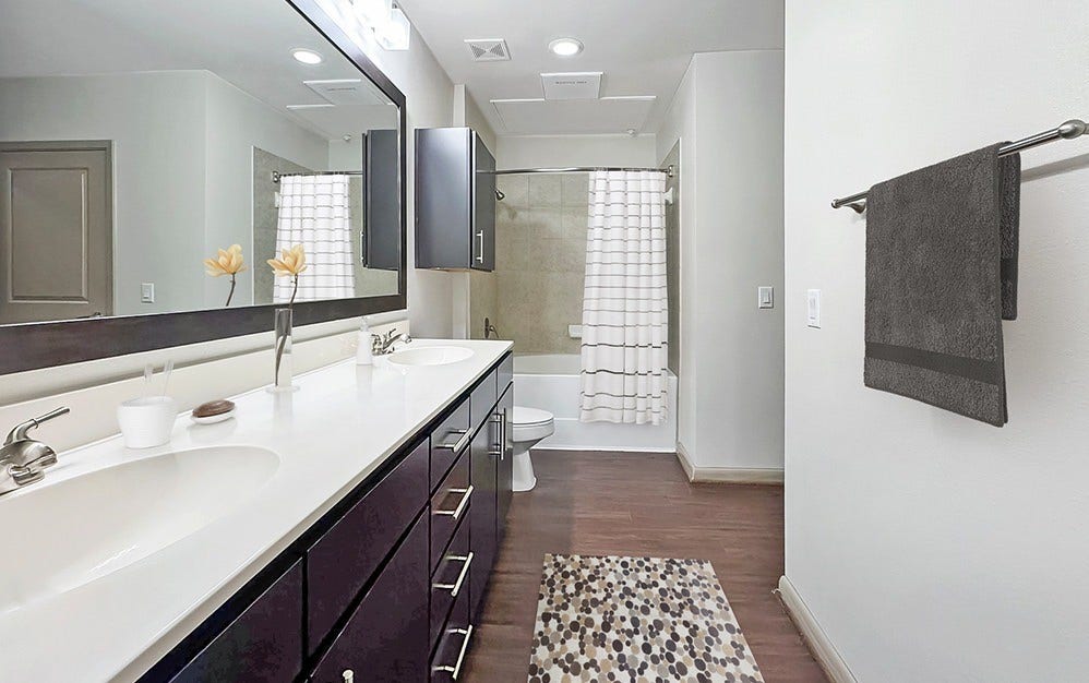 306 McGowen Street, #3306, Houston, TX 77006 A little extra space makes everyday routines feel more luxurious. This beautifully appointed bathroom features an expansive double-sink vanity, generous counter space, rich cabinetry and a soaking tub with shower. Everything is thoughtfully arranged to make mornings easier and evenings more relaxing.