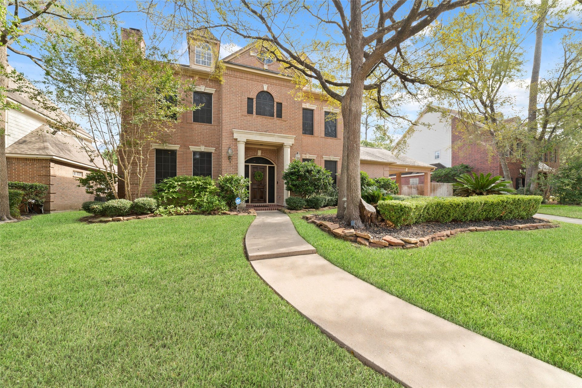 16114 Lafone Drive, Spring, TX 77379 Mature trees, established landscaping and an elegant column framed entry create a picturesque front view.