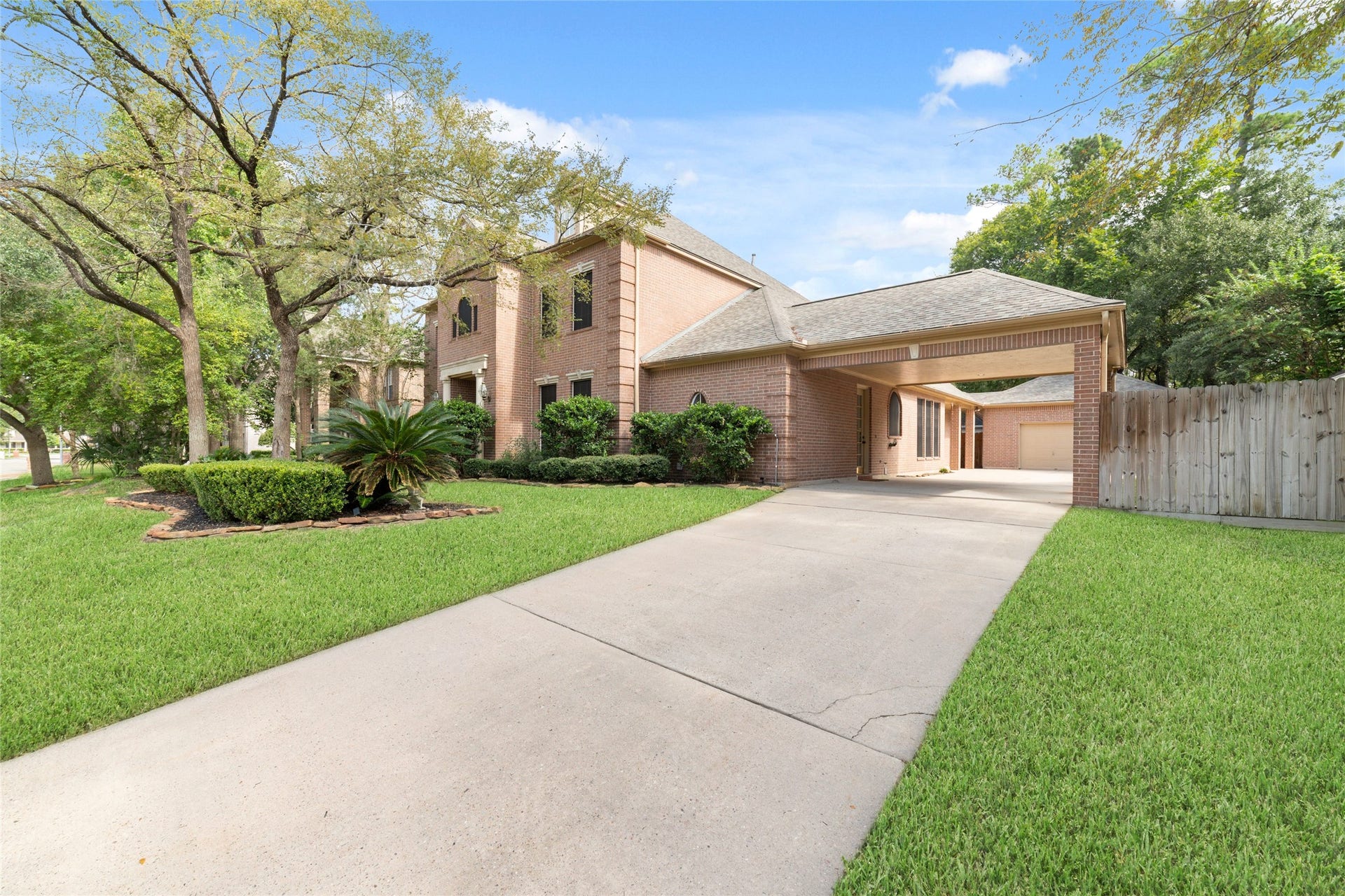 16114 Lafone Drive, Spring, TX 77379 Extended driveway leads to the porte-cochere and detached garage.