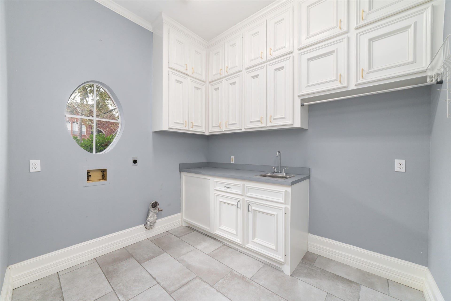 16114 Lafone Drive, Spring, TX 77379 Spacious utility room with tons of cabinetry and a utility sink for added convivence.