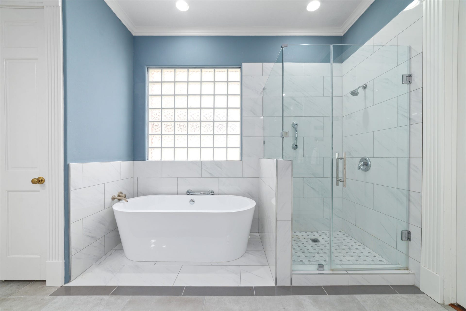 16114 Lafone Drive, Spring, TX 77379 Spa-inspired primary bathroom with a freestanding soaking tub and oversized glass-enclosed shower creates a relaxing retreat at the end of the day.