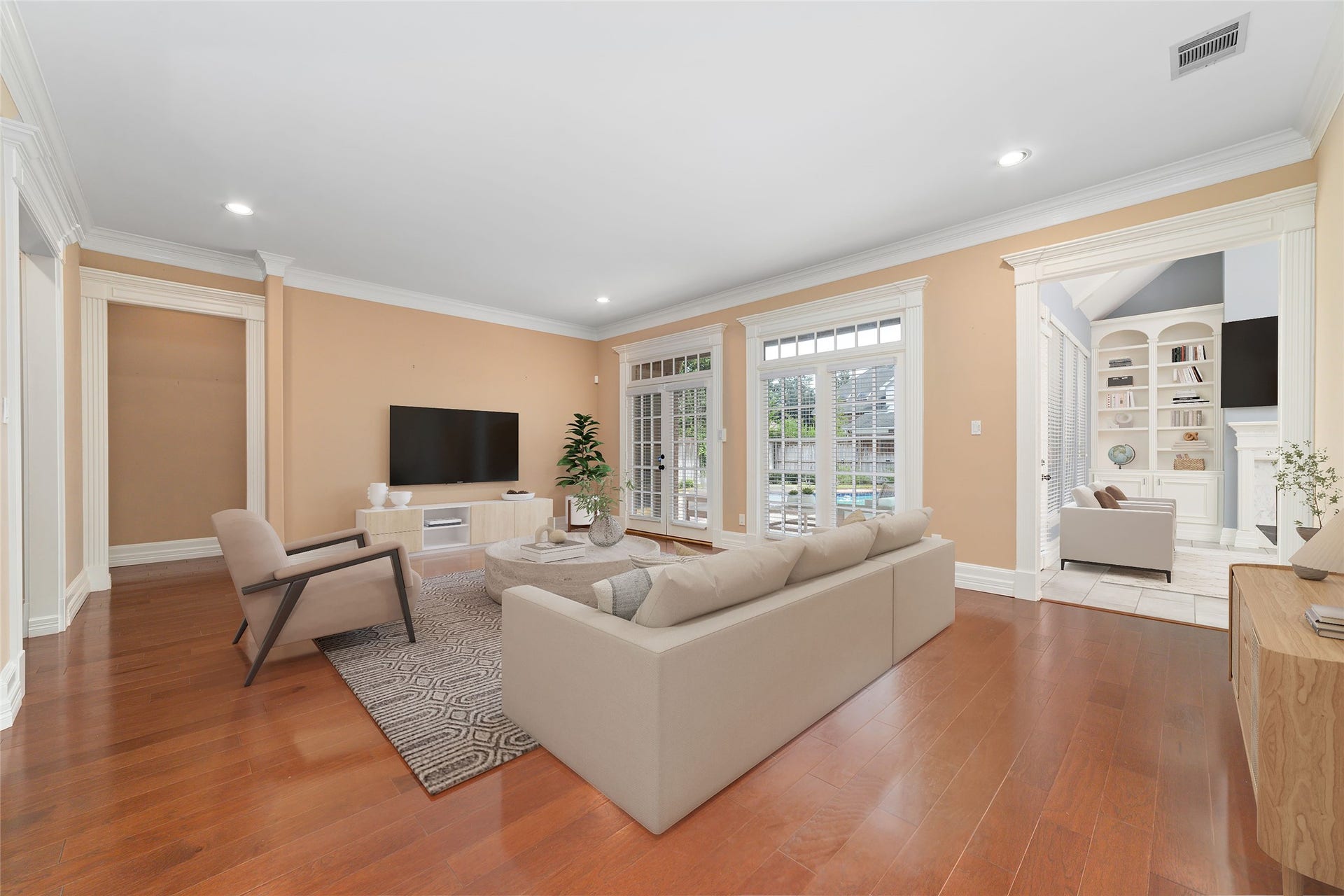 16114 Lafone Drive, Spring, TX 77379 Soaring ceilings and a wall of windows fill this spacious family room with natural light while offering beautiful views of the backyard and pool. Virtually staged.
