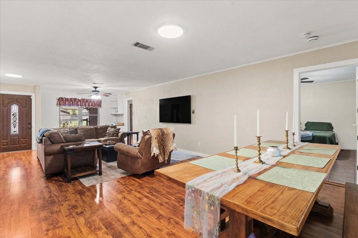 1209 E Brown Lane, Deer Park, TX 77536 Spacious open-concept living area with warm hardwood floors.