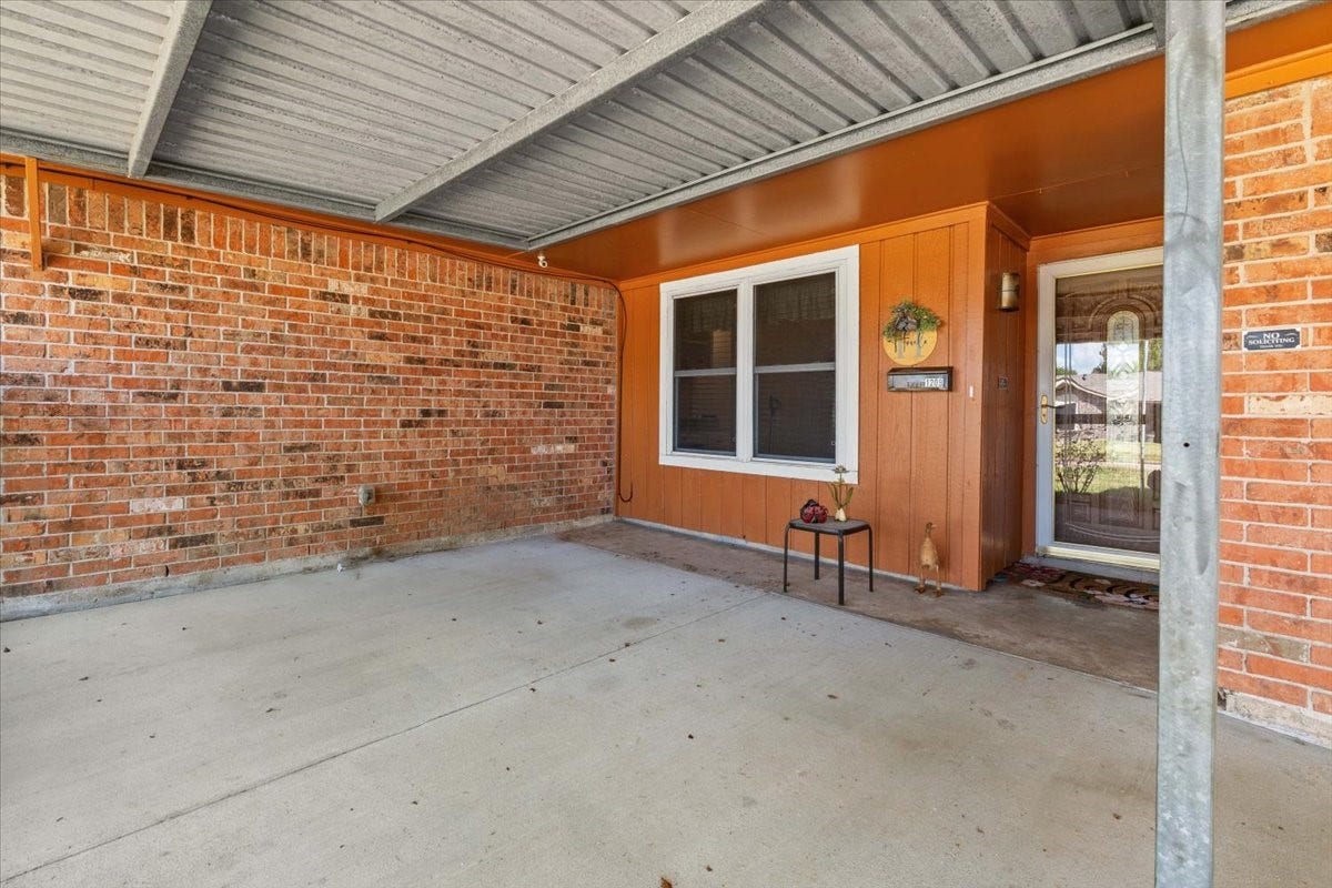 1209 E Brown Lane, Deer Park, TX 77536 Charming covered patio with a welcoming entrance, perfect for relaxing or greeting guests.