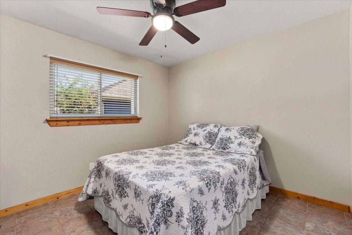 1209 E Brown Lane, Deer Park, TX 77536 3rd bedroom with new ceiling fan, and a window allowing natural light to brighten the space.