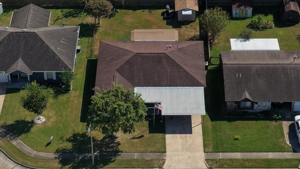 1209 E Brown Lane, Deer Park, TX 77536 Charming single-story home with a spacious front yard, covered carport, and mature trees. Ideal for comfortable living on a quiet cul-de-sac street