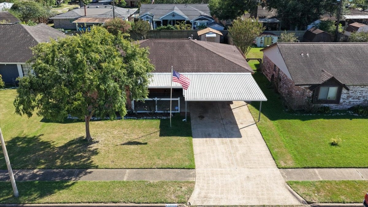 1209 E Brown Lane, Deer Park, TX 77536 Charming single-story home with a welcoming front porch and a spacious carport. The large tree in the front yard provides ample shade, enhancing the curb appeal. Located in a quiet neighborhood, it offers a serene setting with convenient access to local amenities.