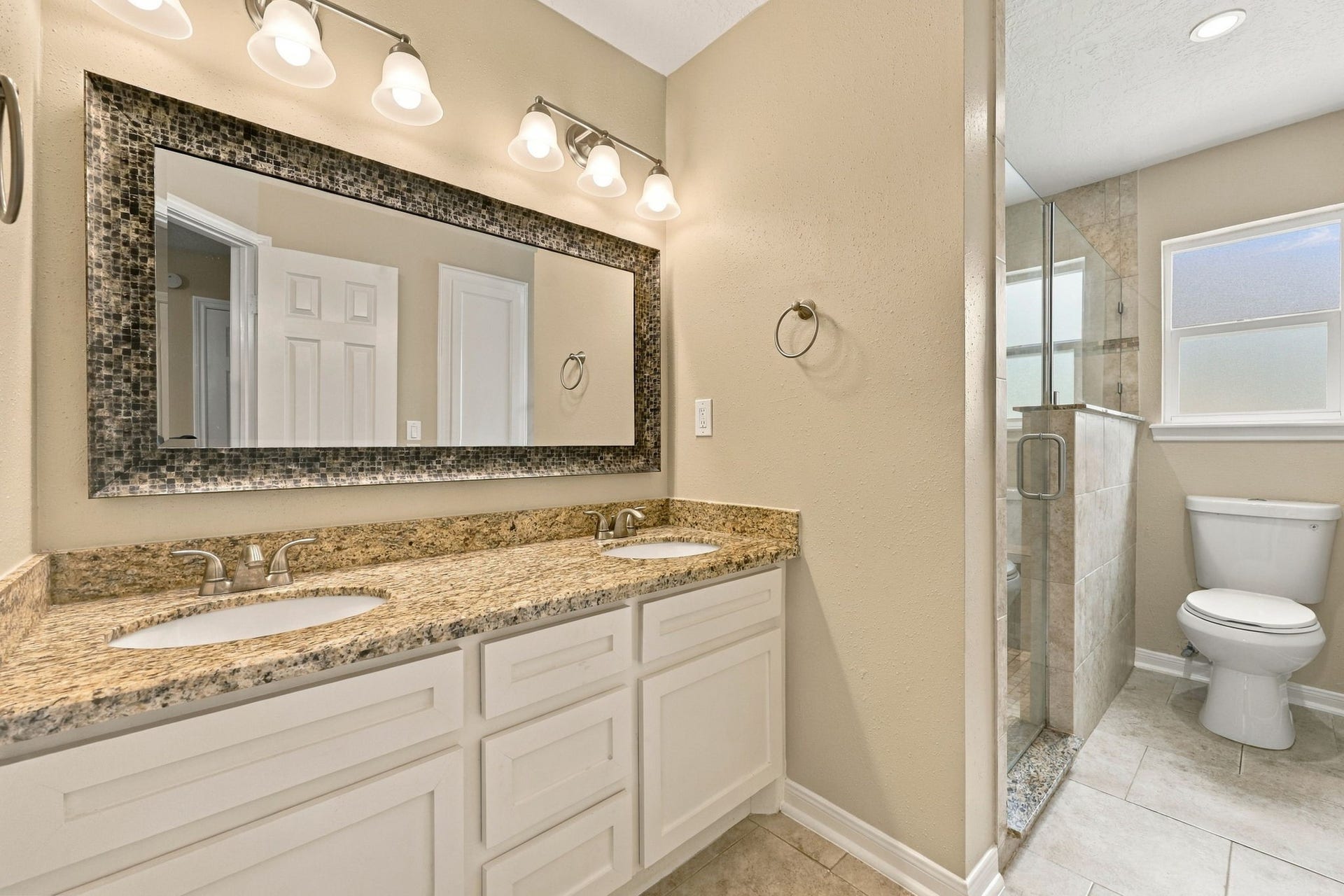 11310 Olympia Drive, Houston, TX 77077 Bathroom connected to the Primary Suite, with double sinks and large walk-in shower.