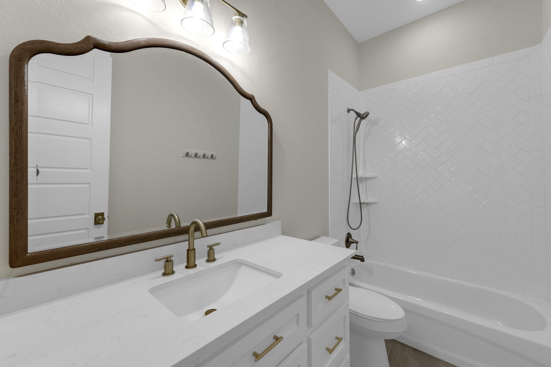 22694 Brook Forest Road, New Caney, TX 77357 Secondary bath features a spacious vanity, upgraded mirror & clean, timeless finishes.