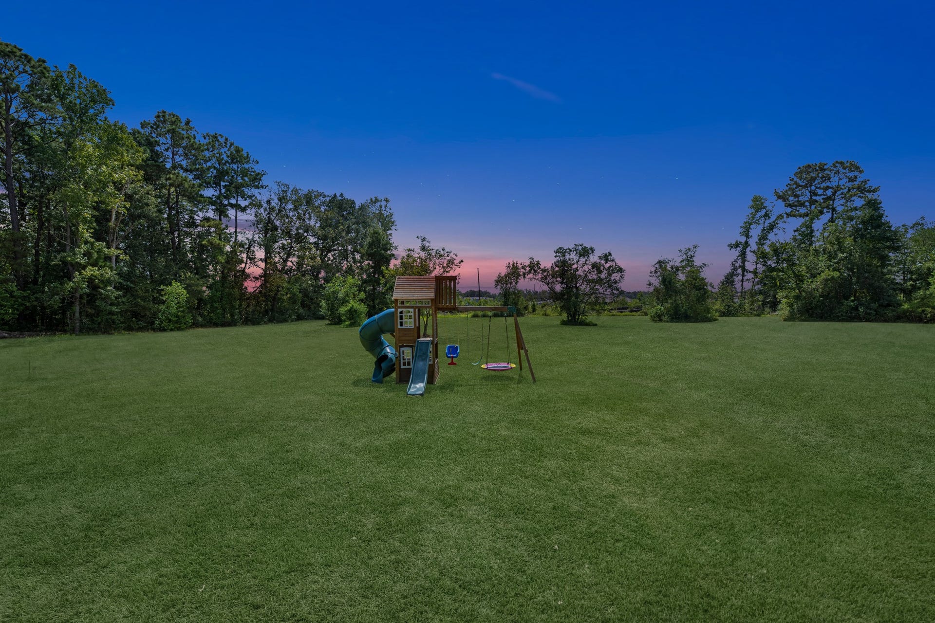 22694 Brook Forest Road, New Caney, TX 77357 Twilight over the backyardpeaceful acreage and wide-open space right outside your door.