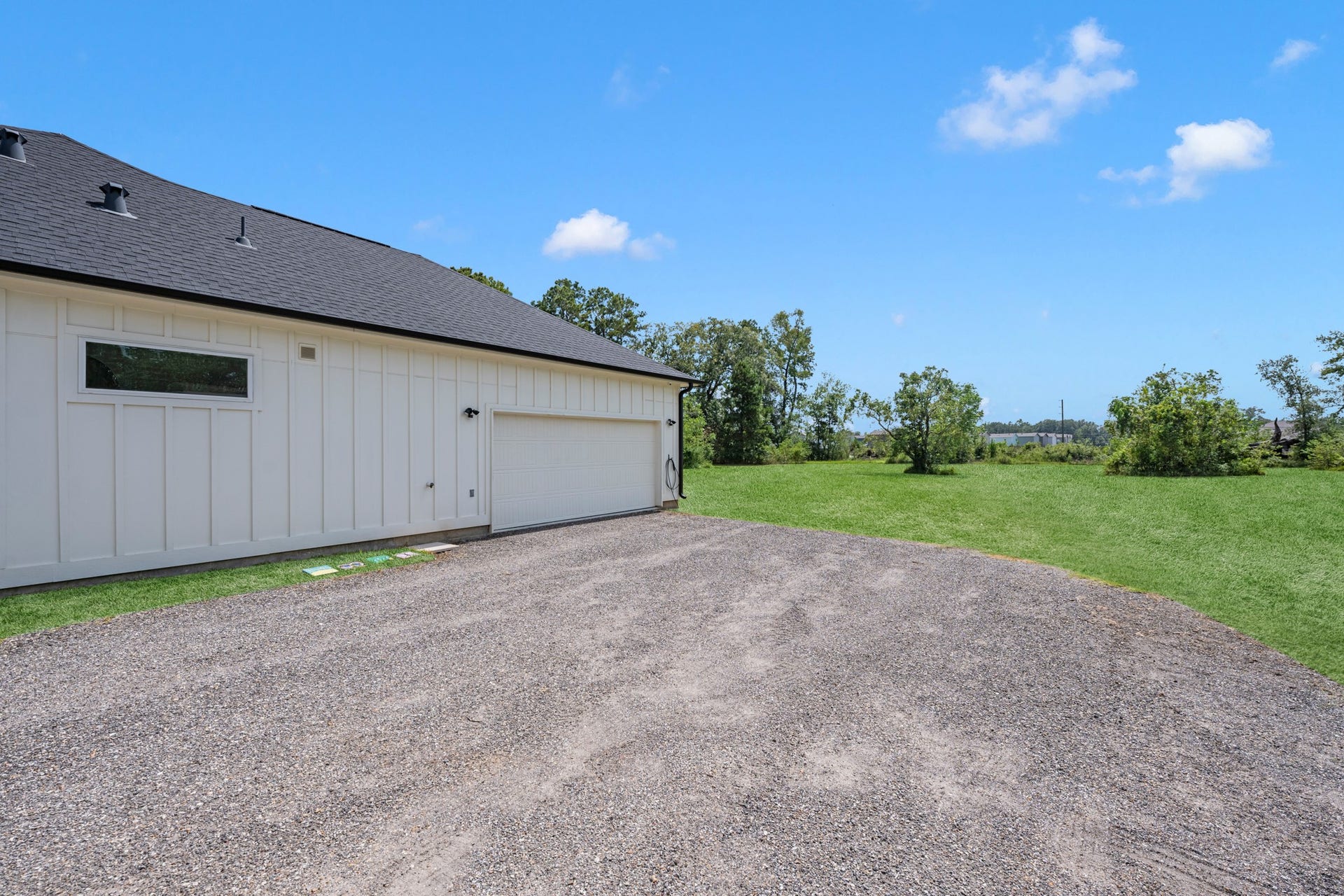 22694 Brook Forest Road, New Caney, TX 77357 Generous driveway and parking area in front of garage complement the home's private acreage setting.