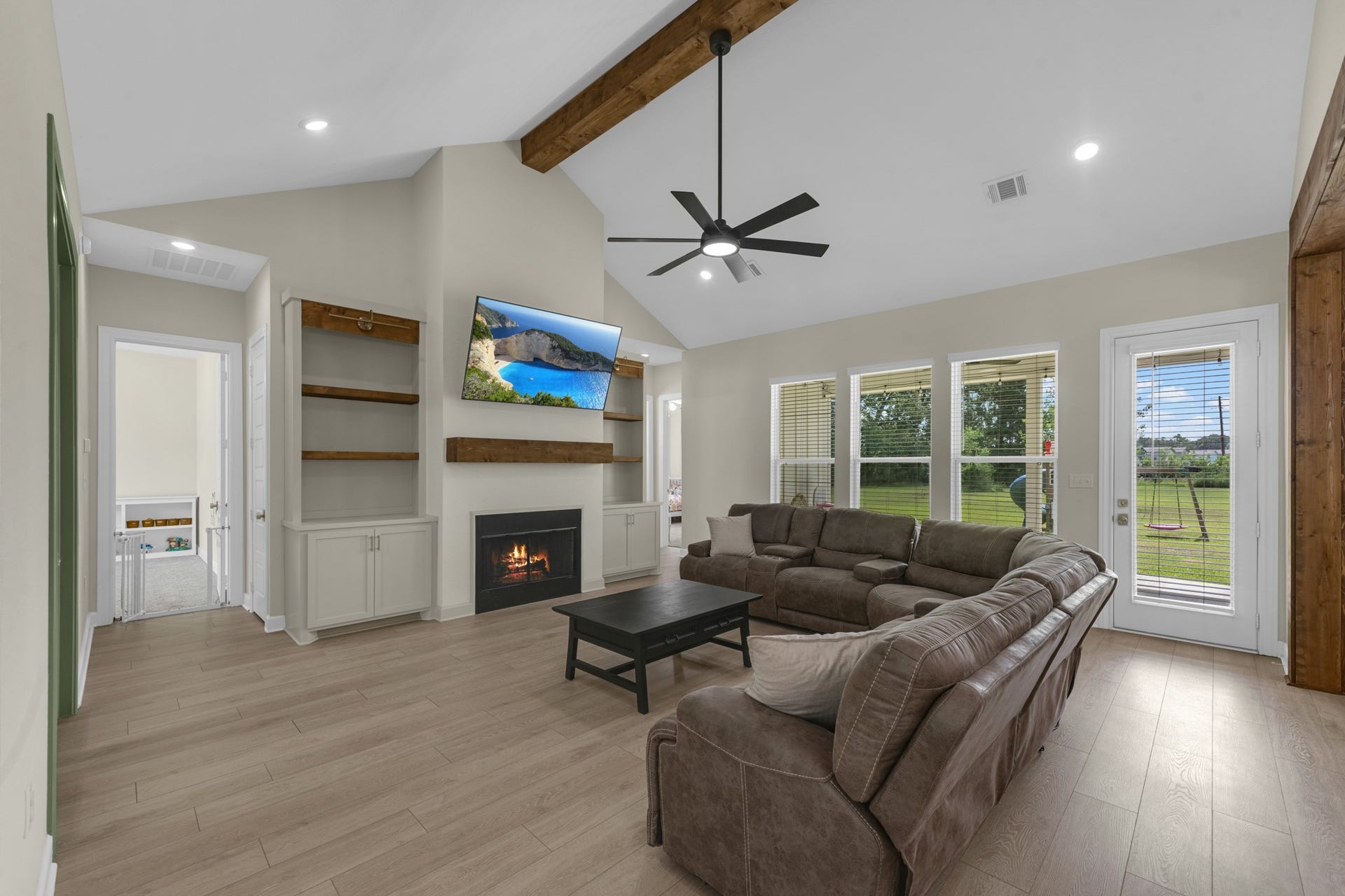 22694 Brook Forest Road, New Caney, TX 77357 Spacious family room with soaring vaulted ceiling, fireplace, custom built-ins & abundant natural light.